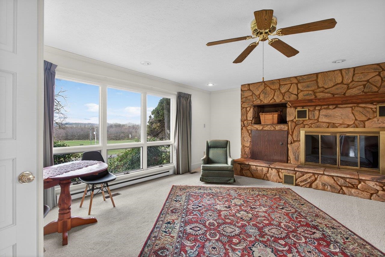 This woodburning fireplace has a built-in storage area for logs, a stone hearth and stone surround. This woodburning fireplace has a built-in storage area for logs, a stone hearth and stone surround.