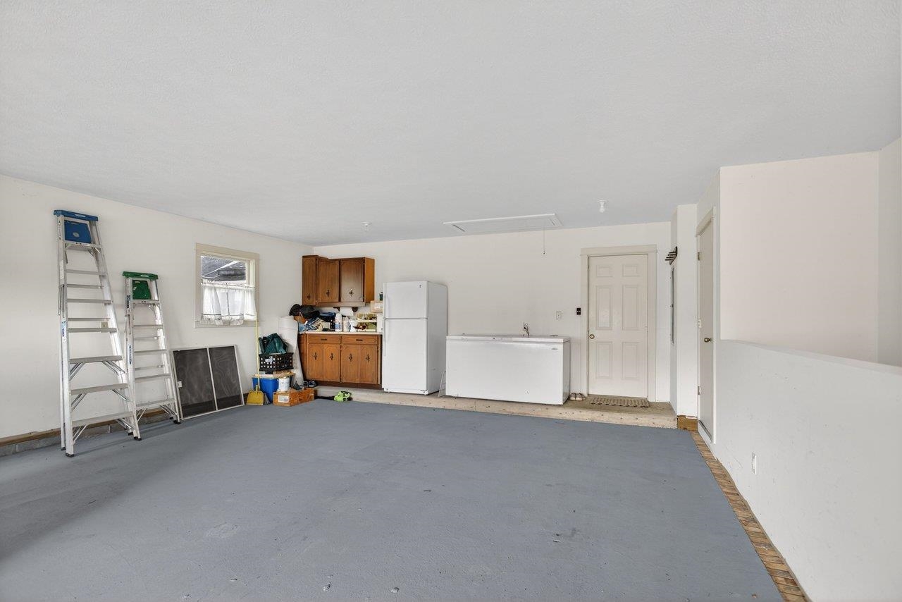 Generously oversized at 700+ square feet. There is also a storage closet, stairs down to the basement and an attached work bench Generously oversized at 700+ square feet. There is also a storage closet, stairs down to the basement and an attached work bench