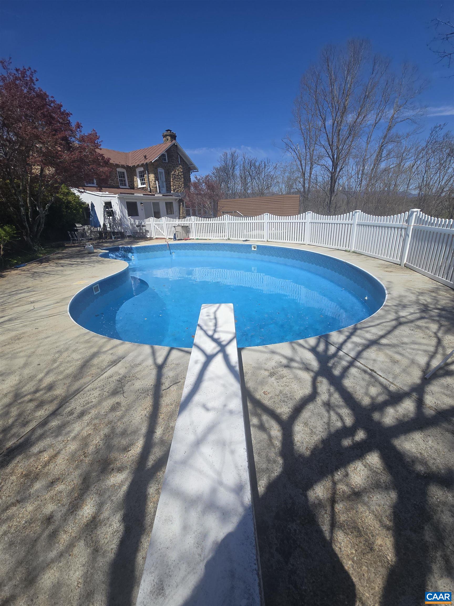 Large outdoor patio, pool and therapeutic swim spa.