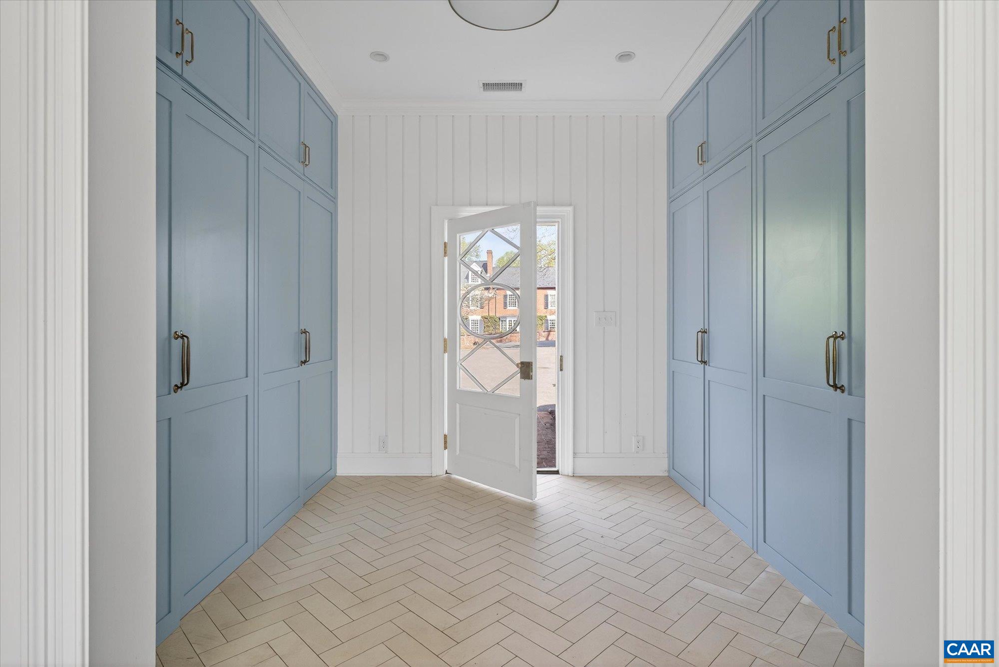 The addition designed by Bethany Puopolo includes this mudroom, adjacent hall bath and hall btw mudroom and kitchen with extensive storage