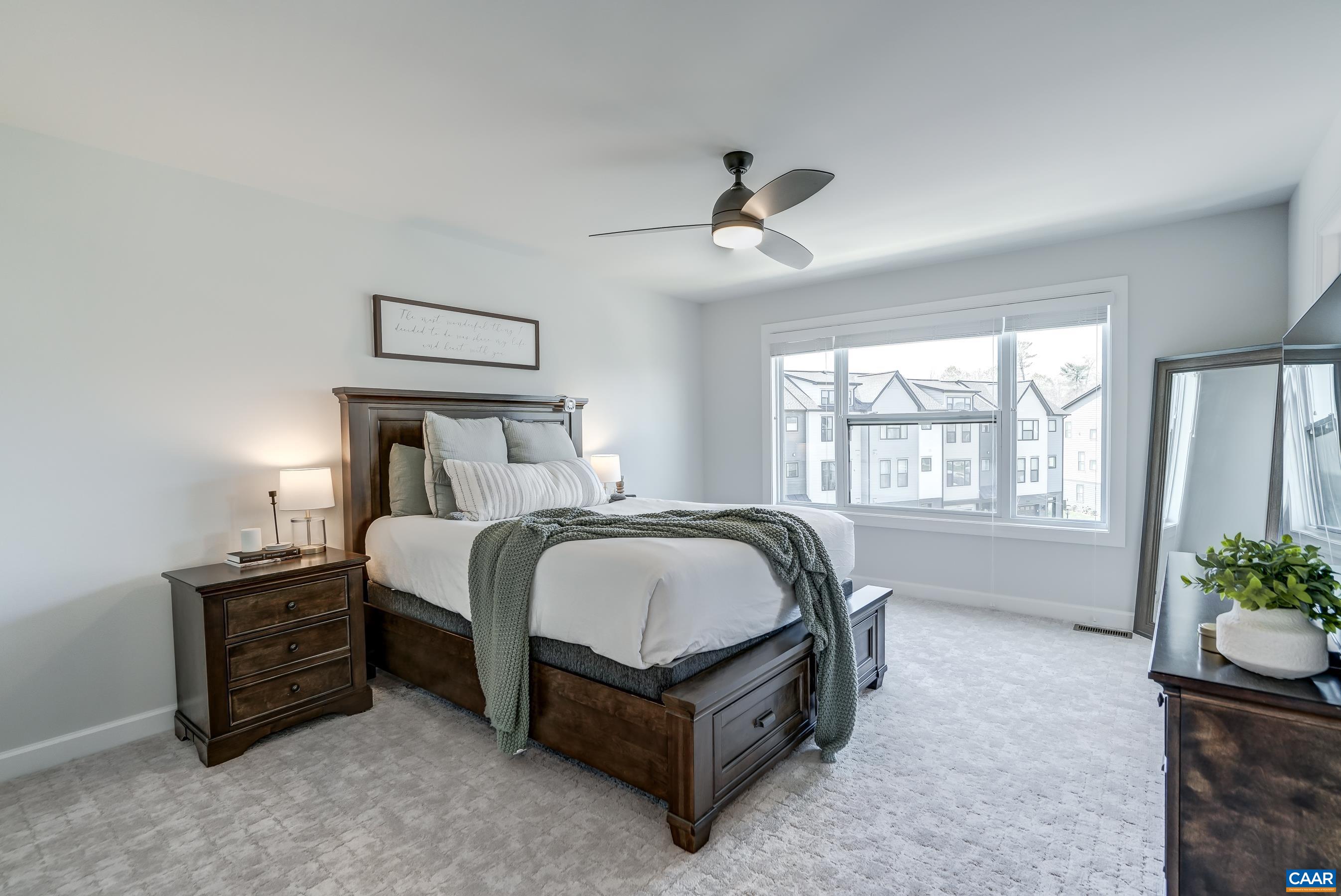 Primary suite with ceiling fan and upgraded carpeting plus a walk in closet and ensuite bathroom.