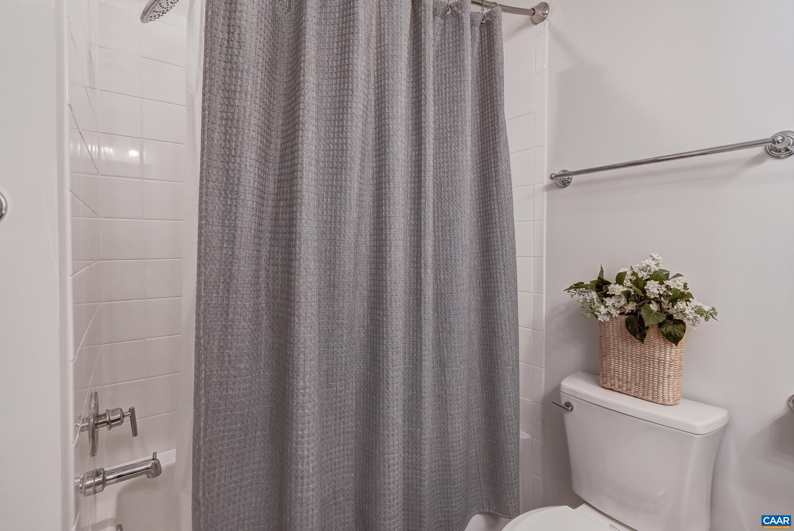 Full bathroom with tub/shower combo.