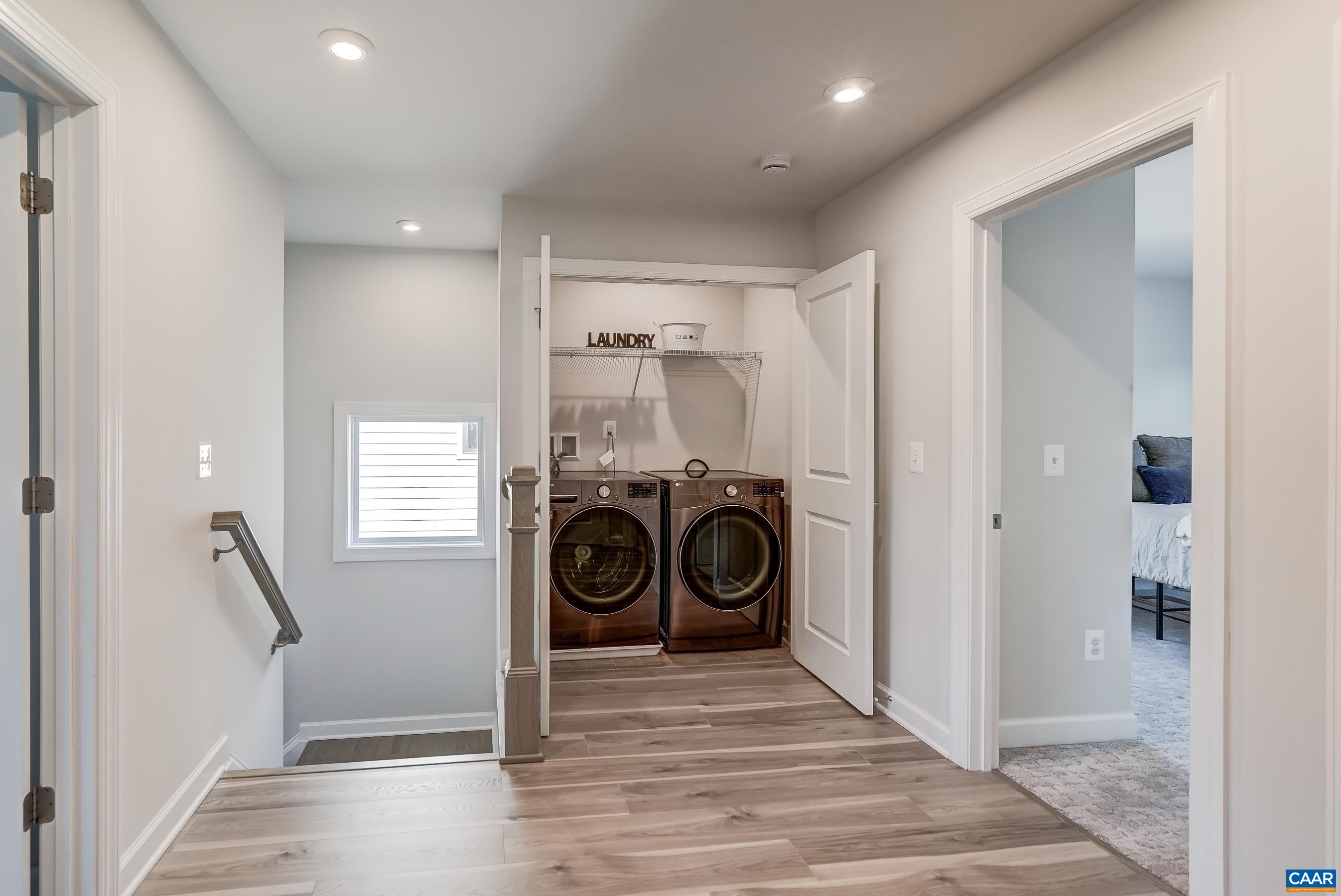 Laundry area conveniently located on the upper level with bedrooms.