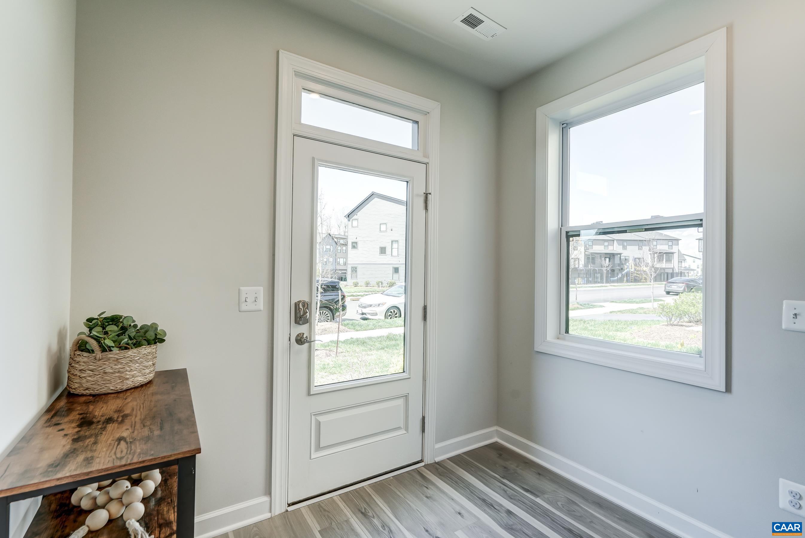 Neutral paint, end-unit extra windows, and light luxury vinyl plank flooring make this home light and bright!