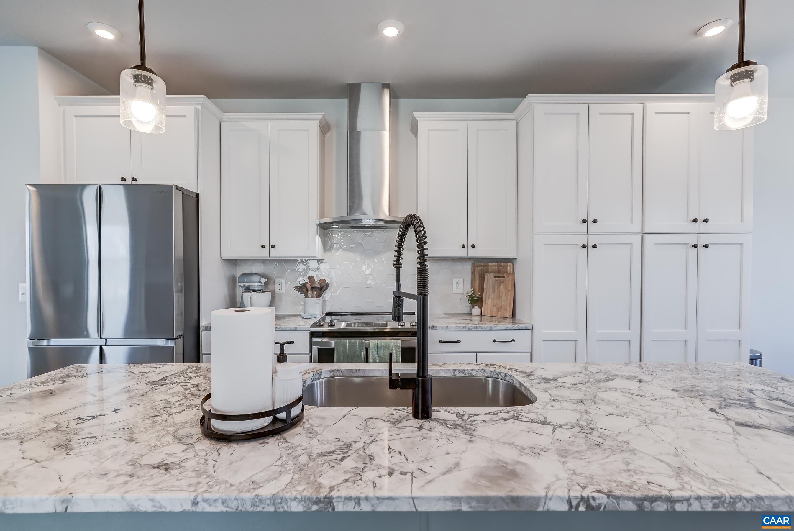 White cabinets, granite counters and stainless appliances sparkle!