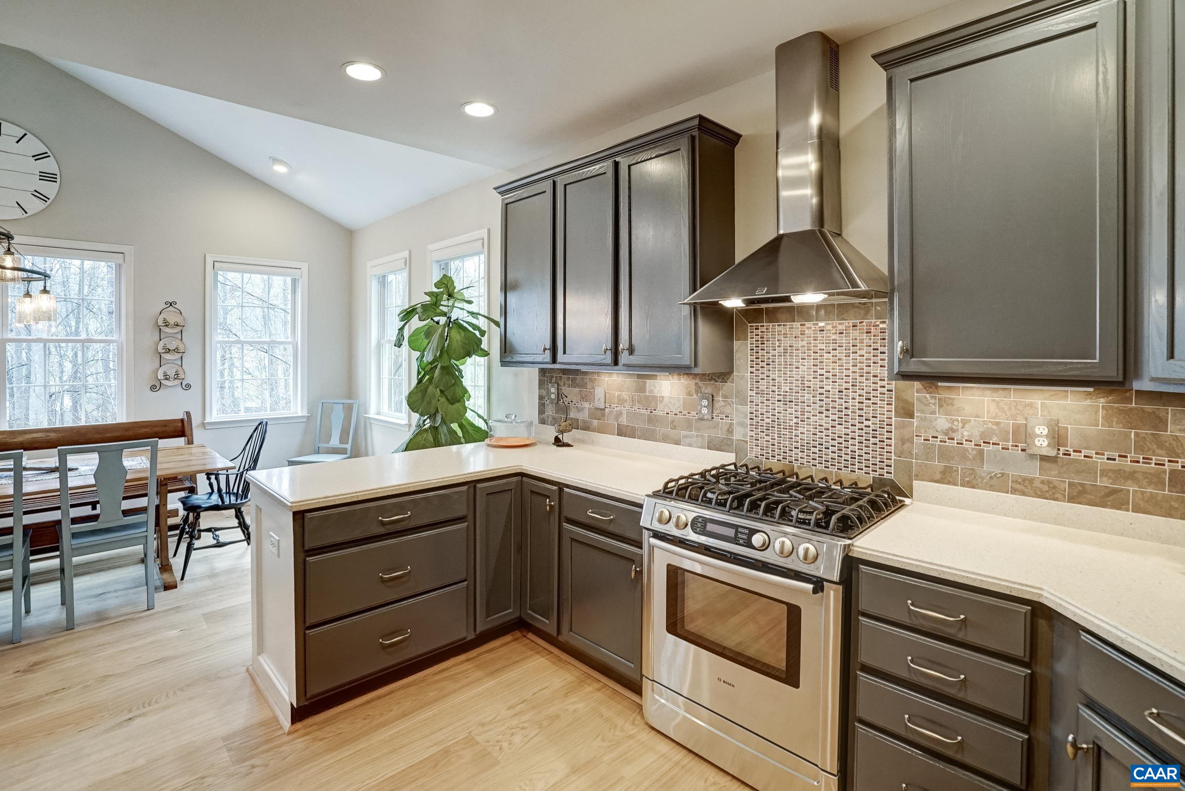 Painted cabinets, solid surface countertops and high-end stainless appliances in this gourmet kitchen!