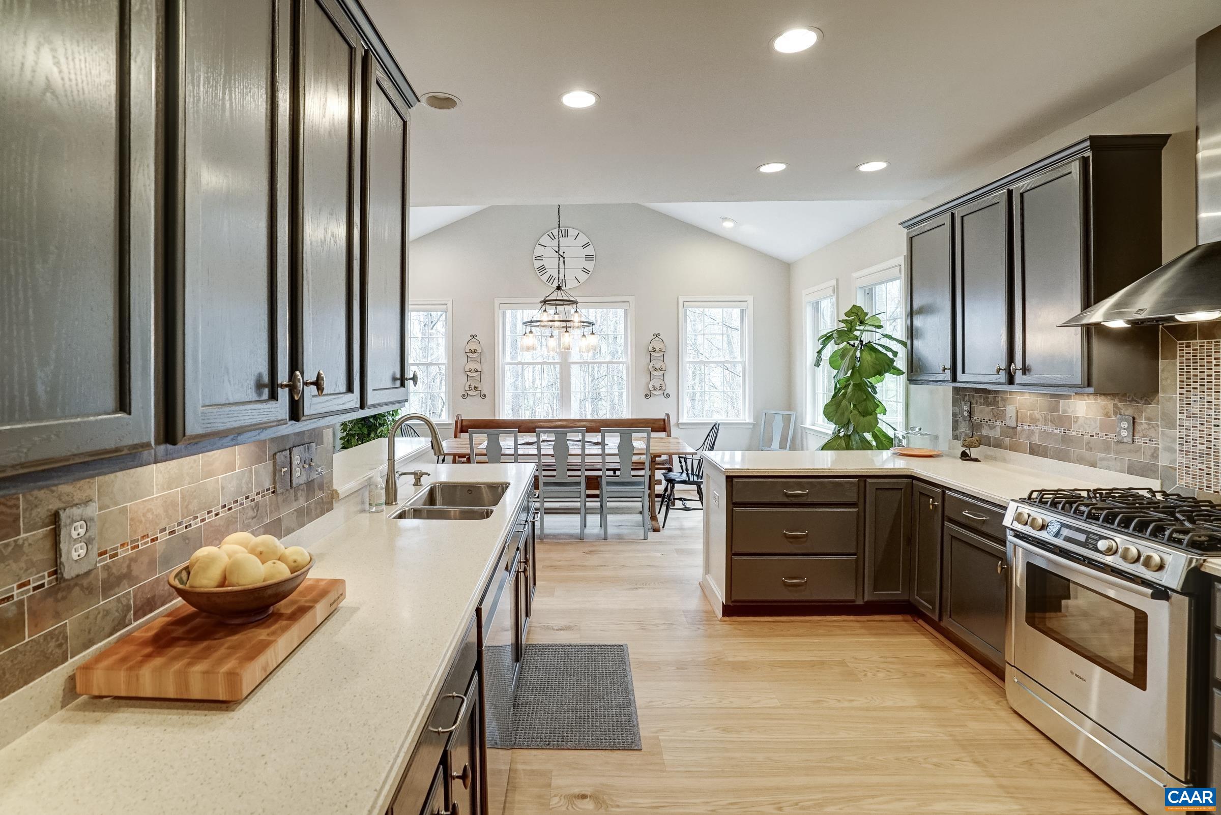 Stainless steel appliances include a dual fuel range, new refriterator, updated dishwasher and microwave.