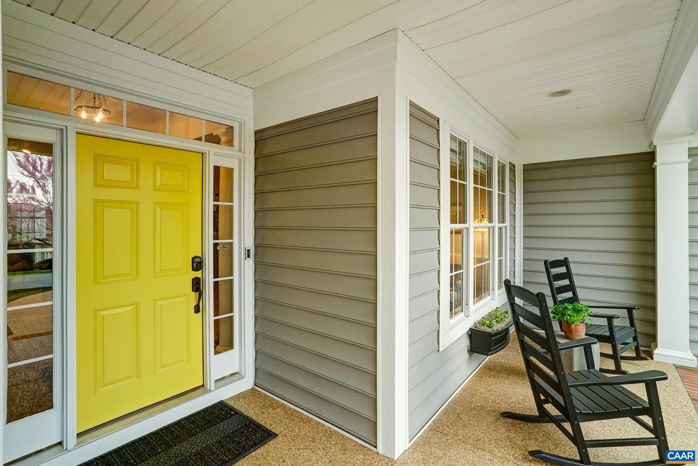 Covered front porch with newly resurfaced aggregate, and cheery, freshly painted front door welcomes you home.