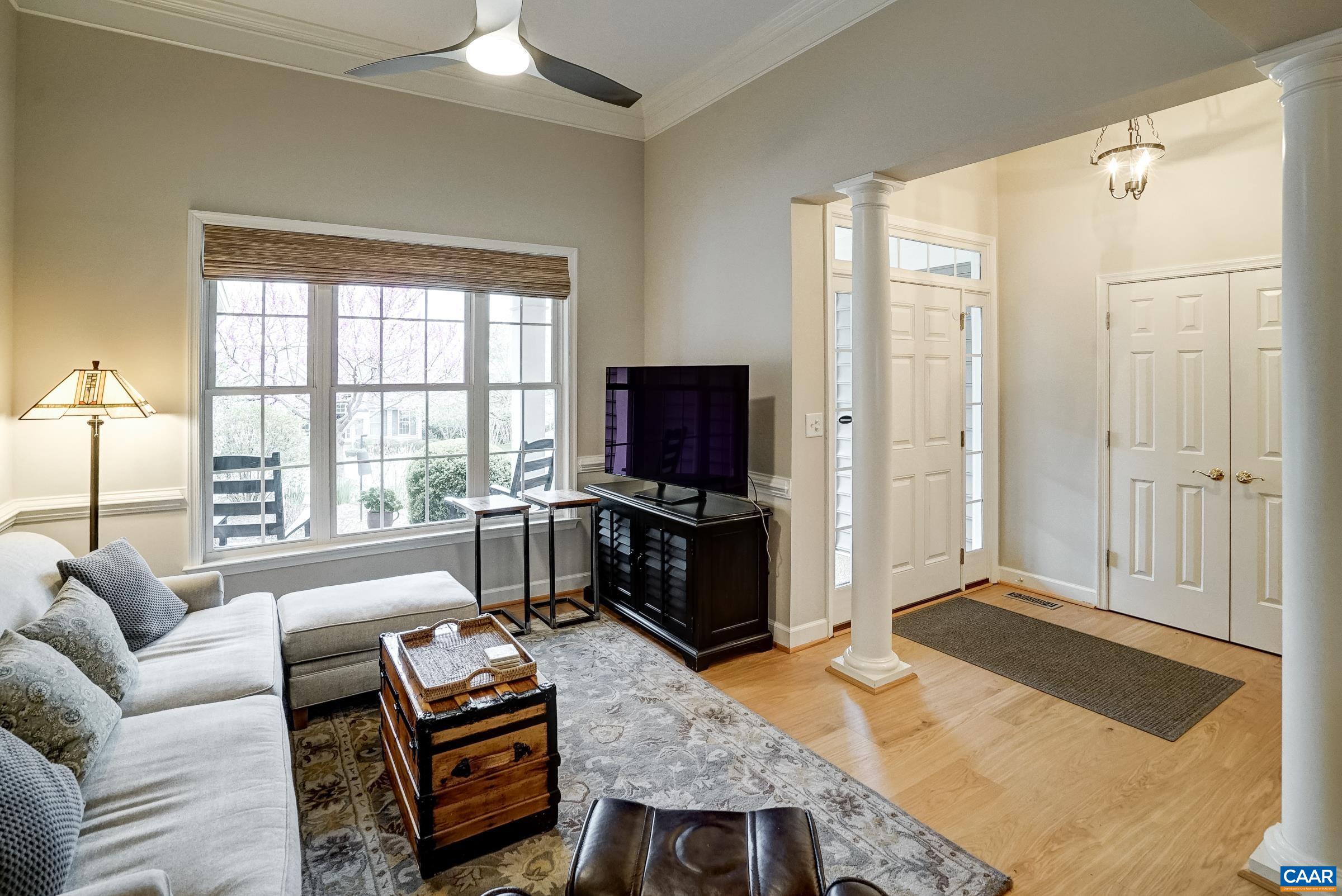 Flexible living space with columns could be a playroom, sitting area or formal living room.