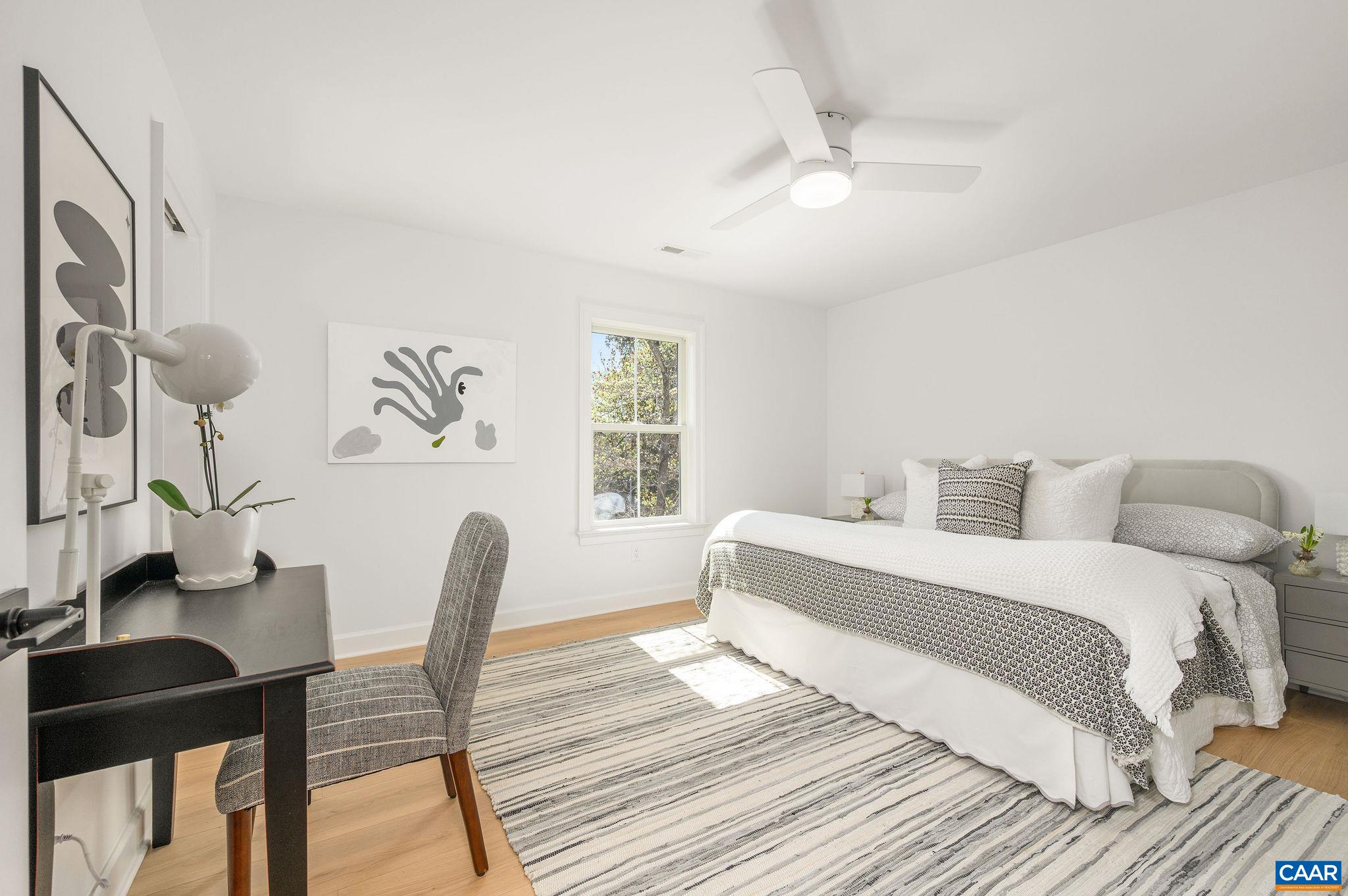 Large primary bedroom with beautiful natural light and en suite bath