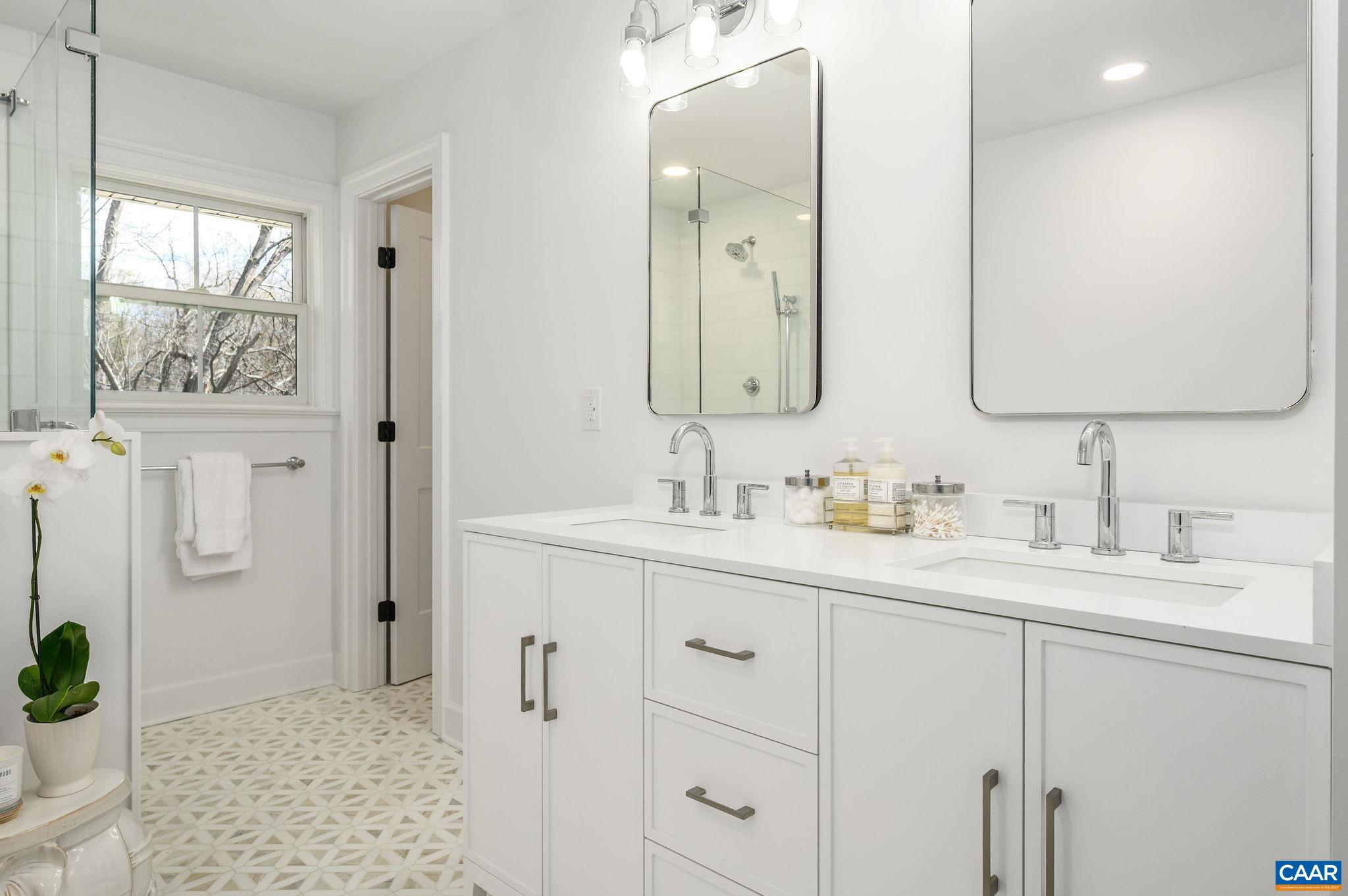 Double sinks, two recessed medicine cabinets and linen/storage closet