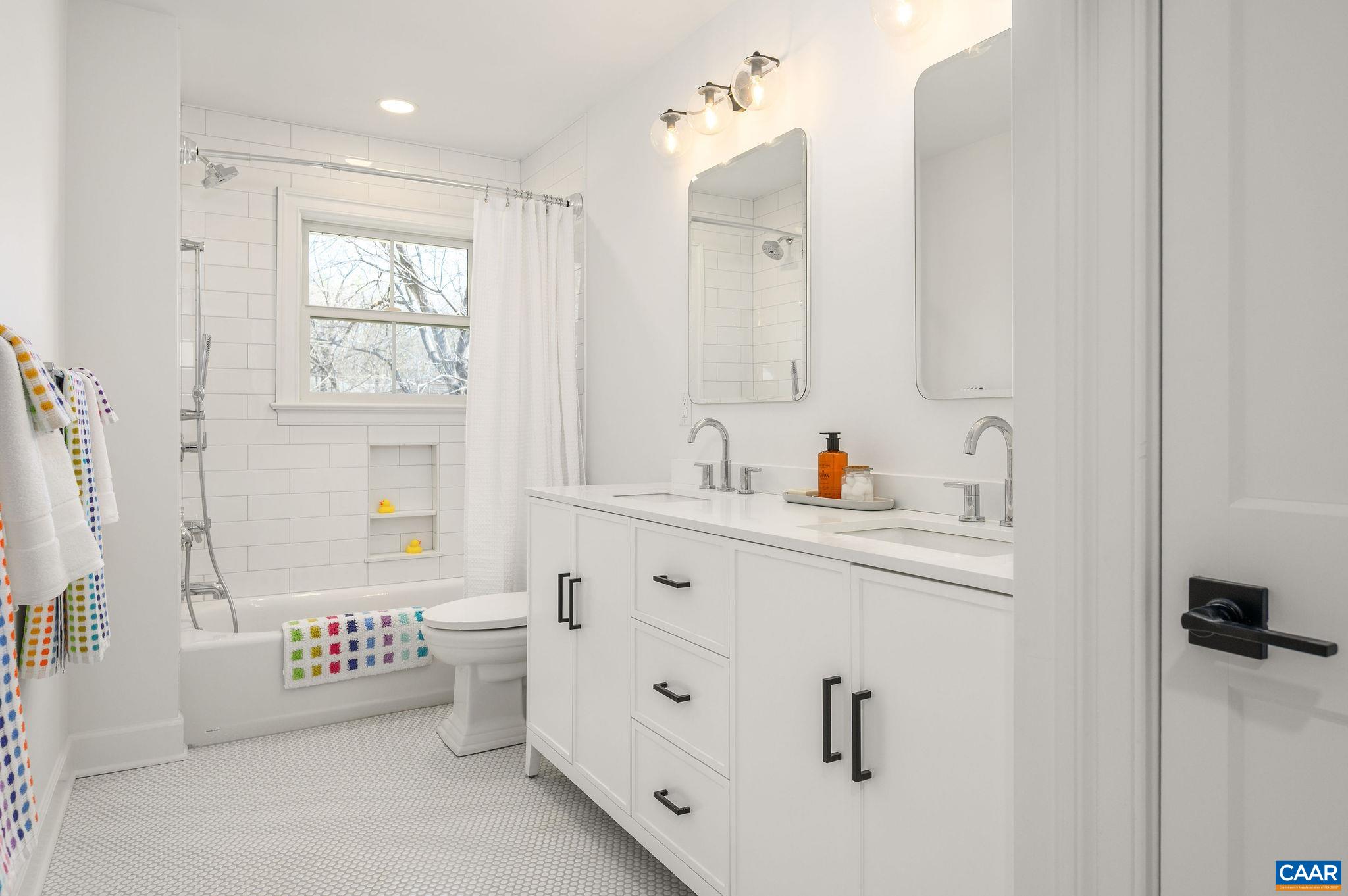 Full bath with double sinks, two recessed medicine cabinets and linen/storage closet