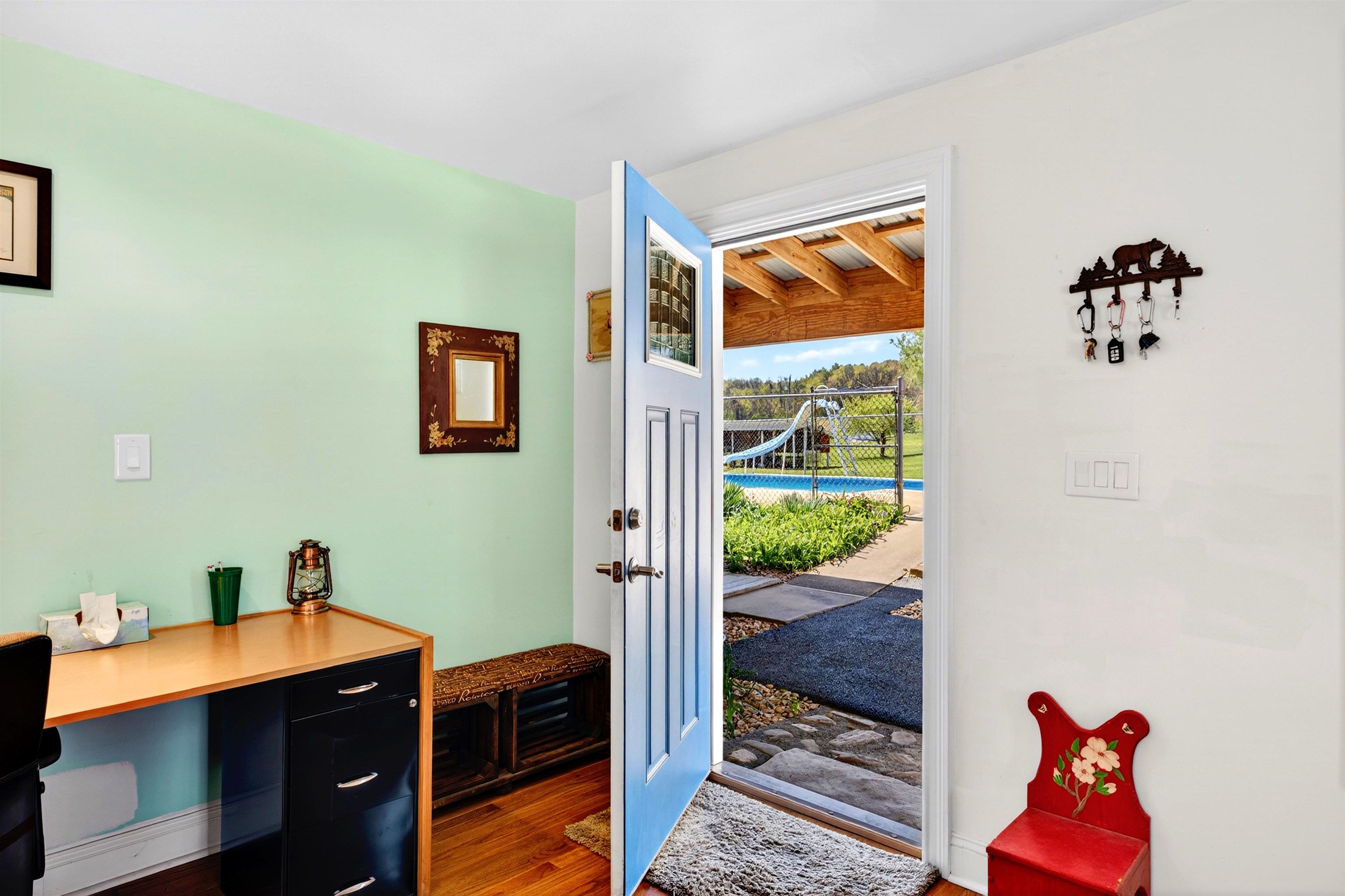 Flexible home office nook with space for a desk and direct access to the outdoor living area and pool — ideal for working with a view.