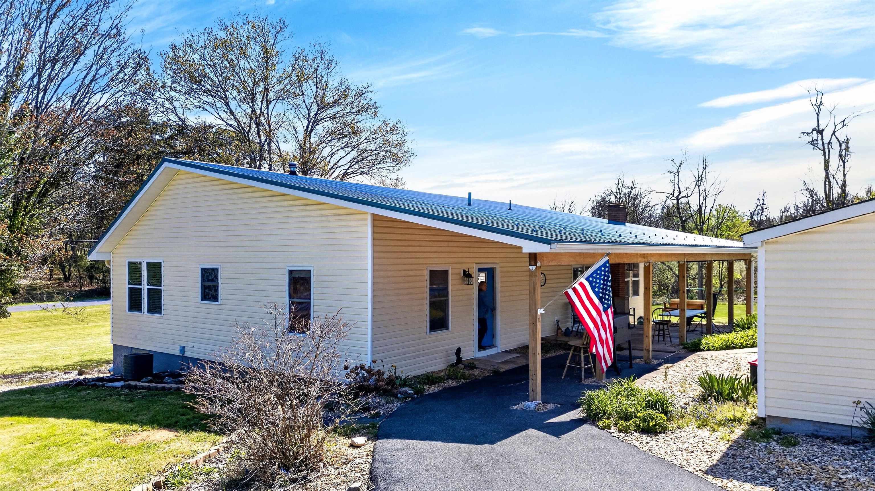 Covered front porch entry with easy access from the driveway, offering comfortable one-level living and a welcoming first impression.