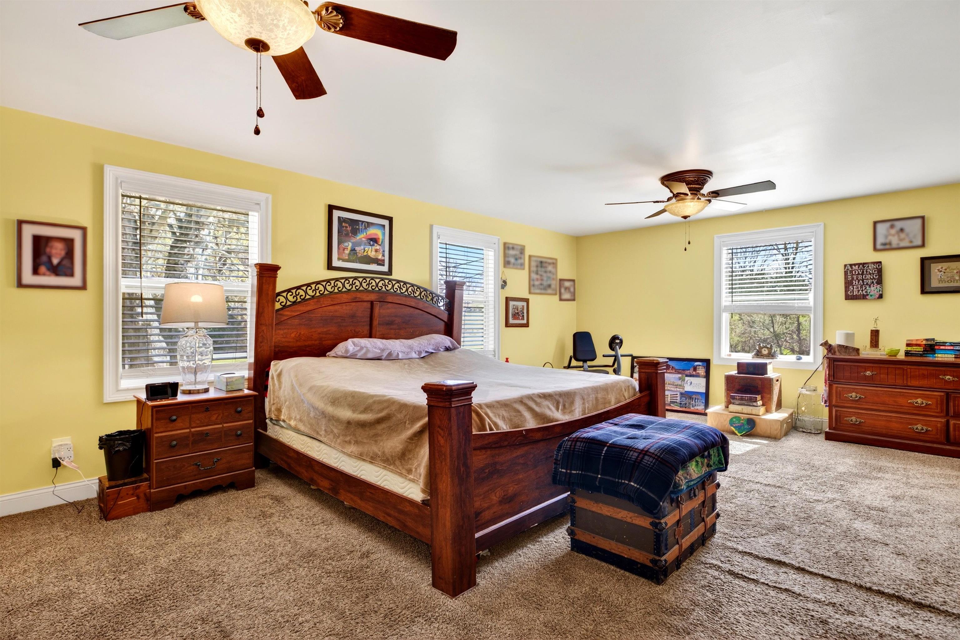 Spacious primary bedroom offering generous layout flexibility, natural light, and direct access to the primary bath for comfortable one-level living.