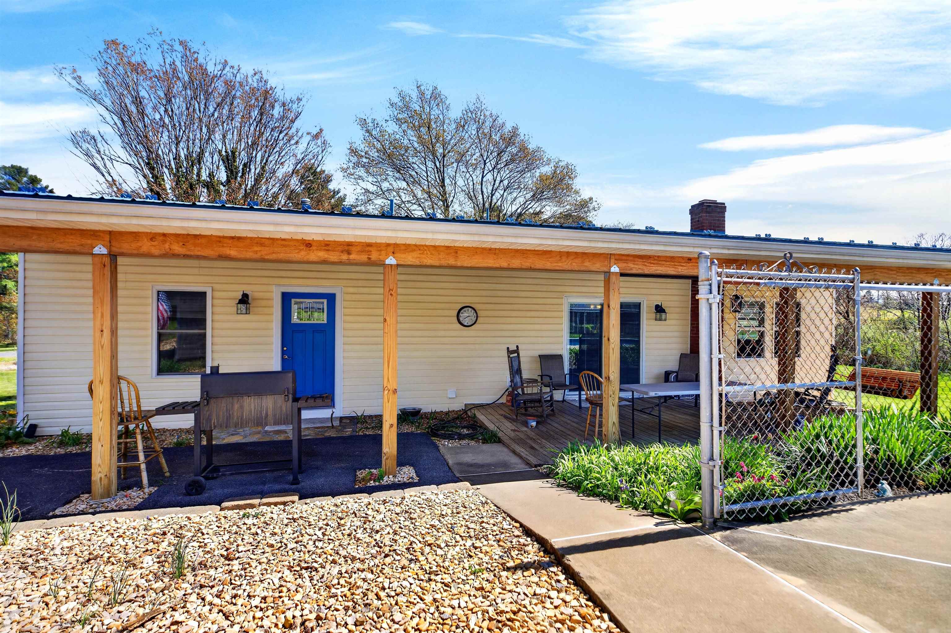 Spacious covered porch offers a comfortable outdoor living area, perfect for relaxing, enjoying the view, or gathering with family and friends.