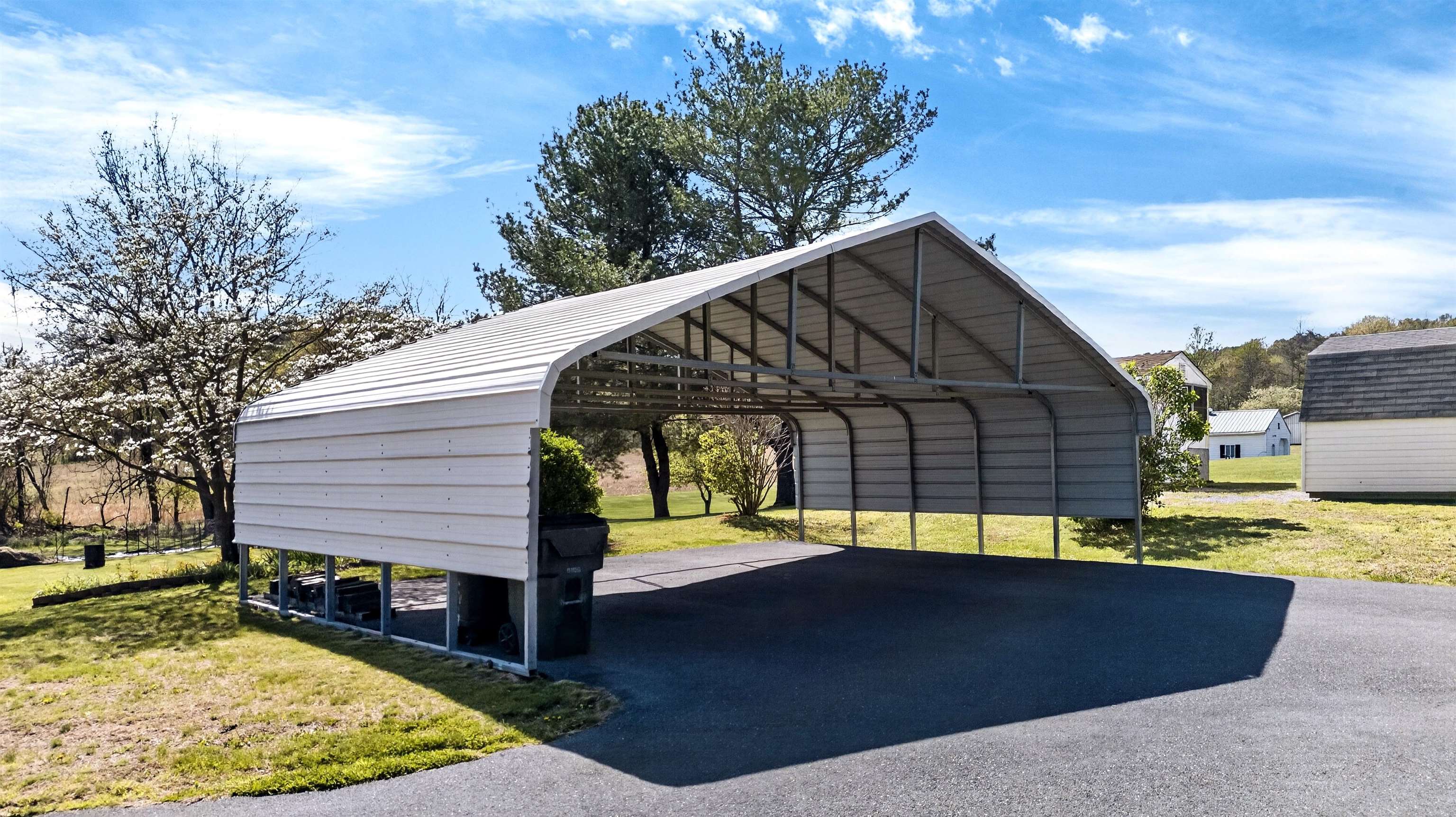 Approx. 30.3' x 20' metal carport providing covered parking or space for equipment, vehicles, or outdoor storage needs.