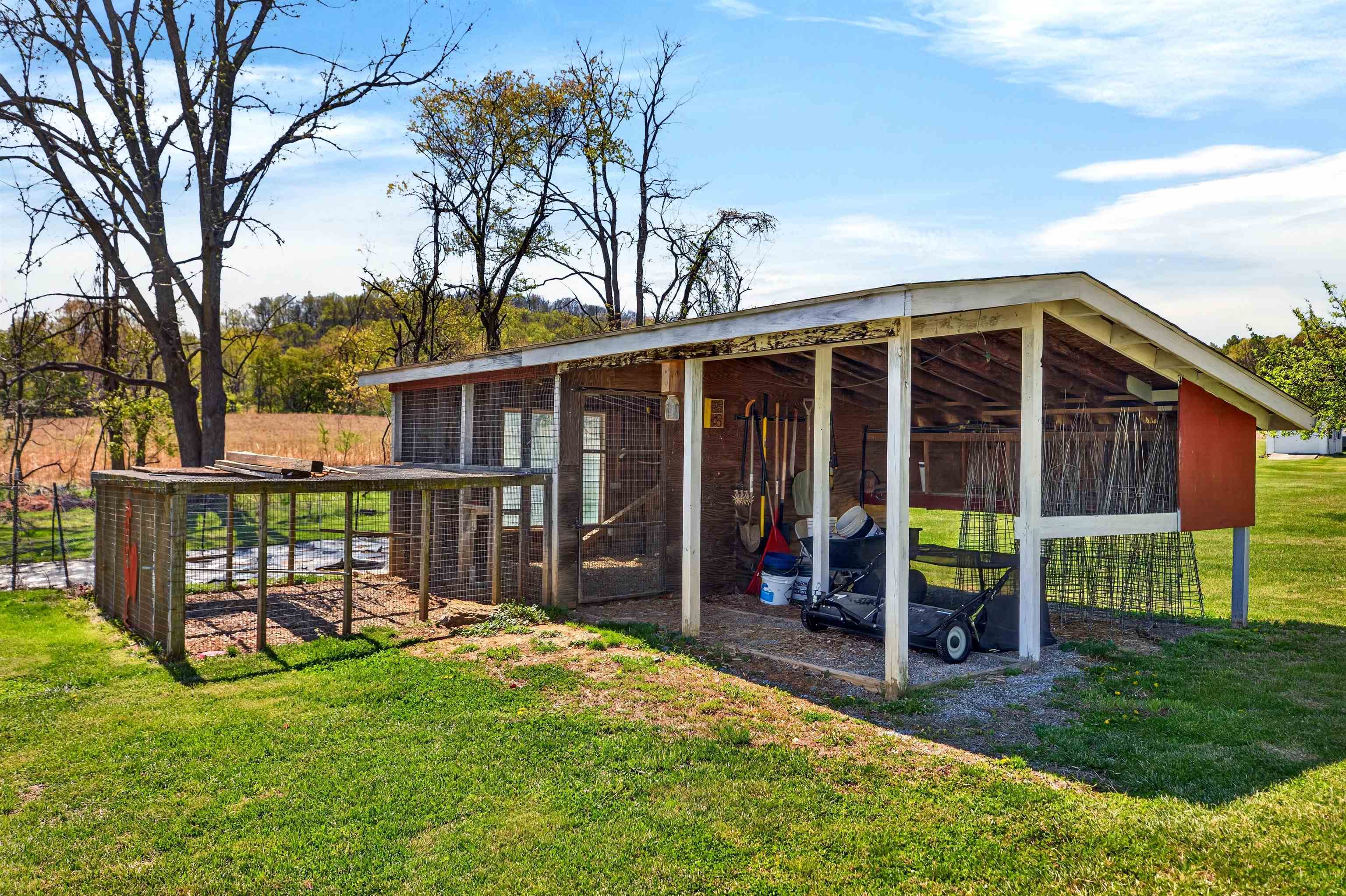 Fenced chicken coop area offering a great setup for small-scale homesteading, fresh eggs, or hobby farming.
