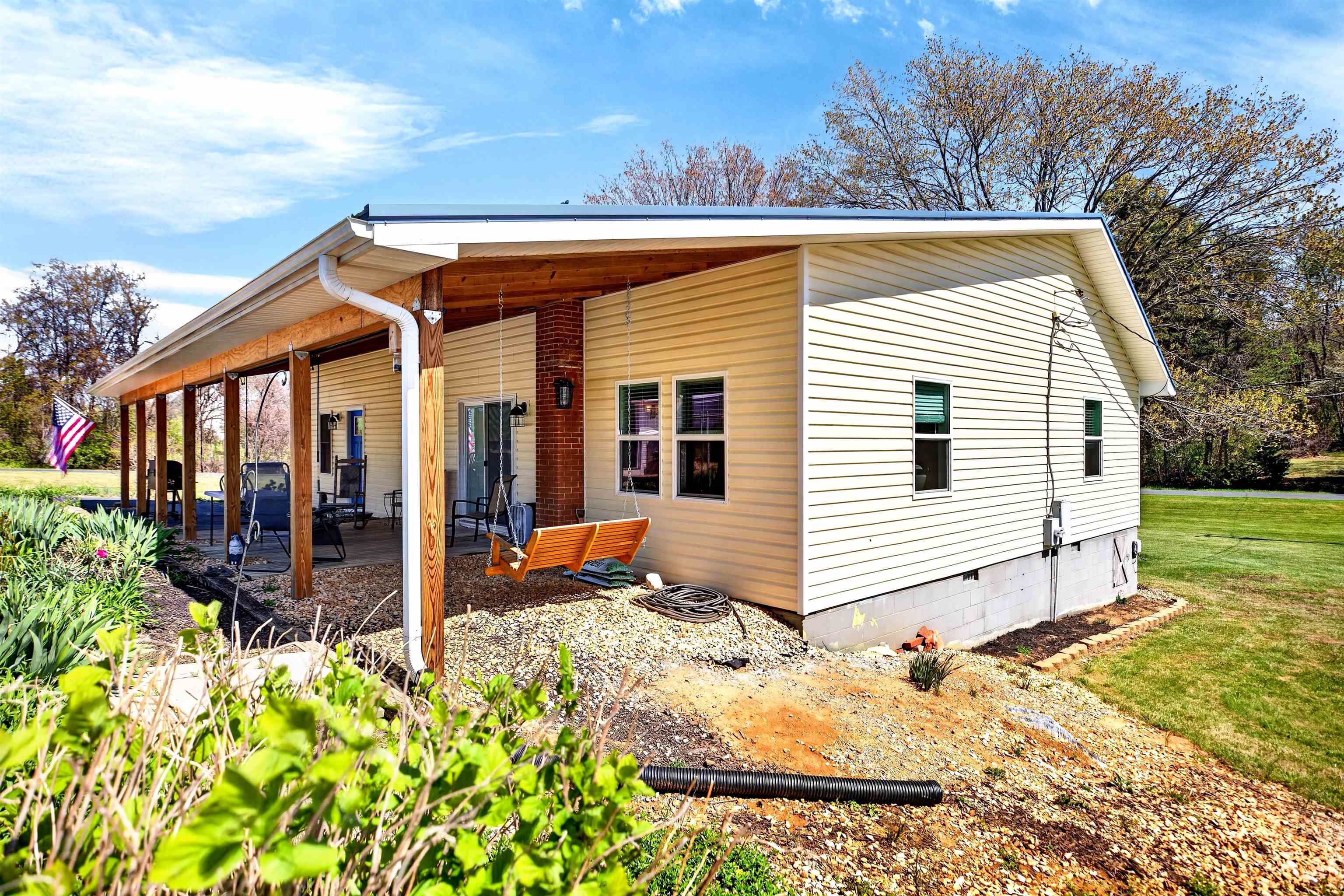 Covered patio area with convenient side entry offers easy indoor-outdoor flow and a great space for relaxing or entertaining.