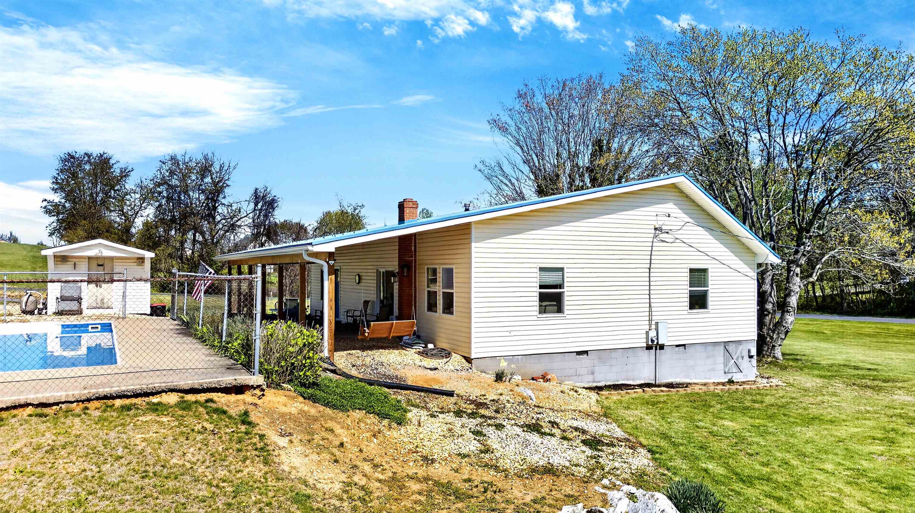 Outdoor living area featuring the pool, patio, and open yard space — designed for relaxing, entertaining, and everyday enjoyment.