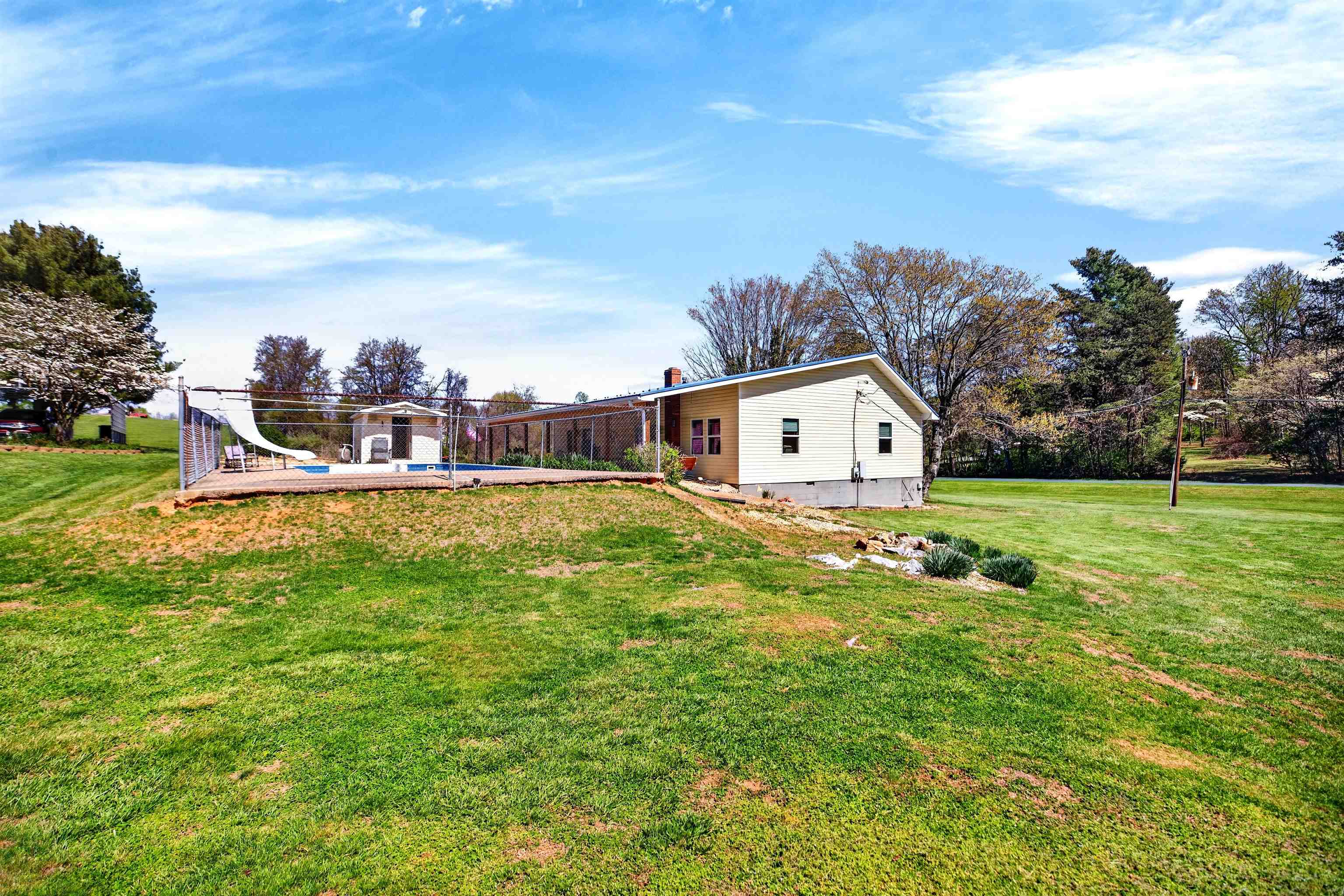 Expansive, mostly level yard offers plenty of usable space for gardening, outdoor activities, or simply enjoying the peaceful setting.