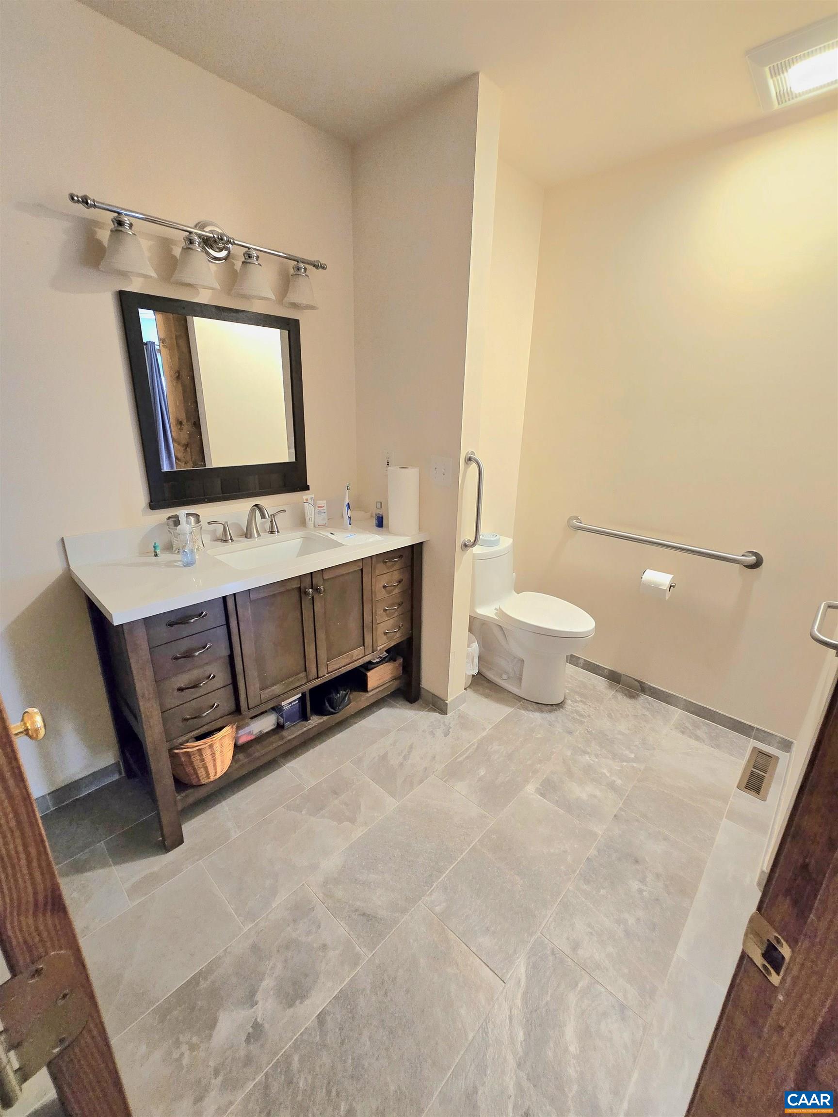 The luxurious Master bath boasts ceramic tile, updated vanity, and beautiful tile shower.