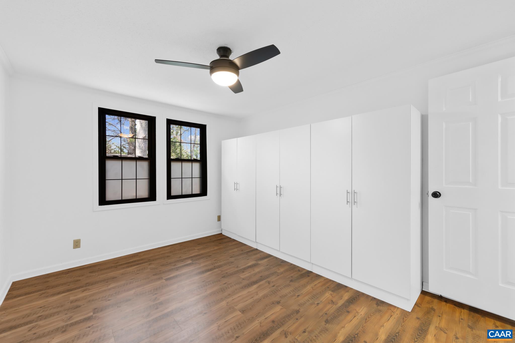 Versatile room for your lifestyle! This bright space can be a comfortable second bedroom or an efficient laundry room, featuring two windows and ample built-in storage. Enjoy the modern ceiling fan and stylish wood-look flooring. Versatile room for your lifestyle! This bright space can be a comfortable second bedroom or an efficient laundry room, featuring two windows and ample built-in storage. Enjoy the modern ceiling fan and stylish wood-look flooring.