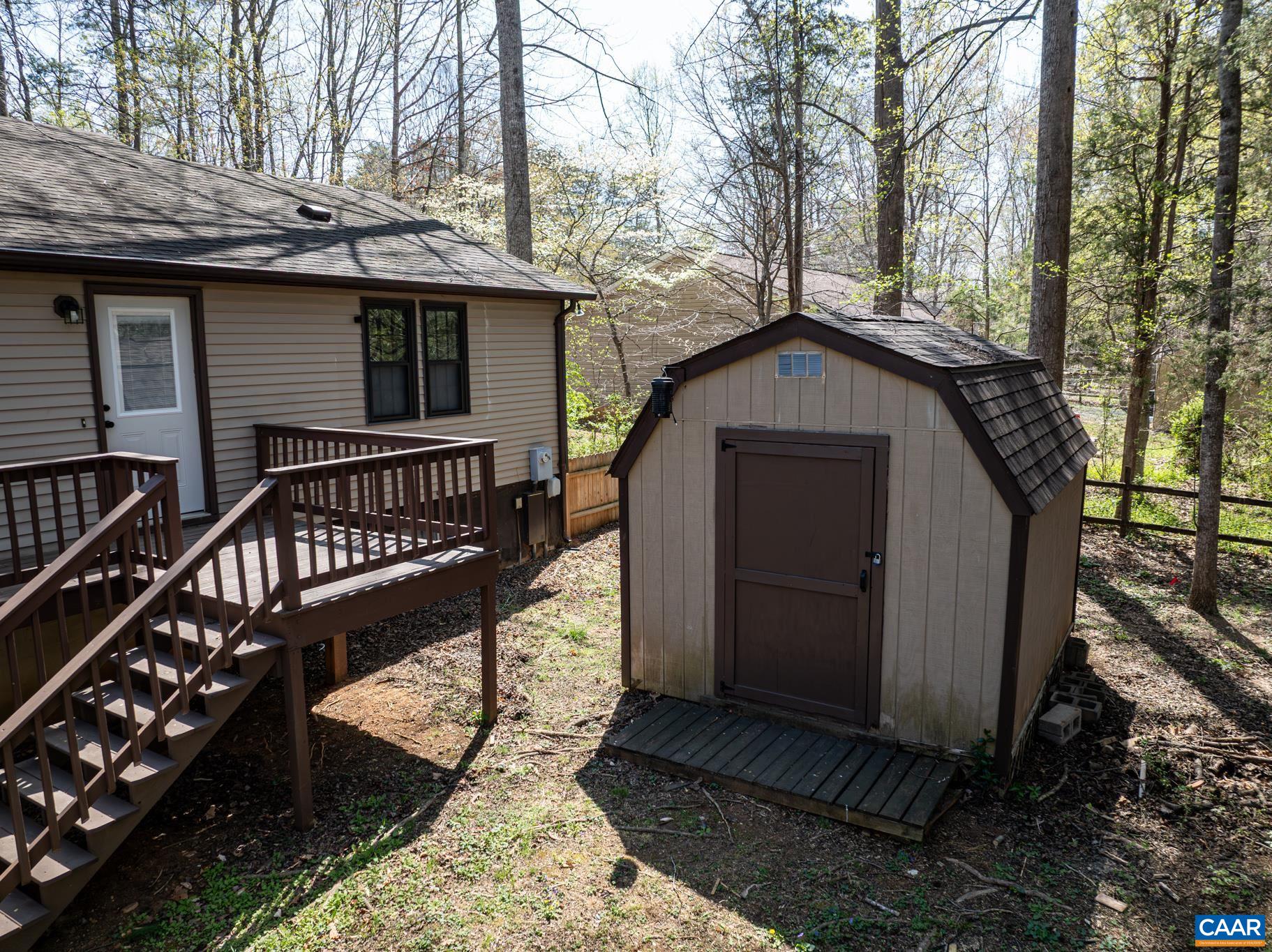 Enjoy a serene backyard setting! This property includes a charming shed for extra storage and a deck perfect for relaxing or entertaining among the trees. Great outdoor space! Enjoy a serene backyard setting! This property includes a charming shed for extra storage and a deck perfect for relaxing or entertaining among the trees. Great outdoor space!