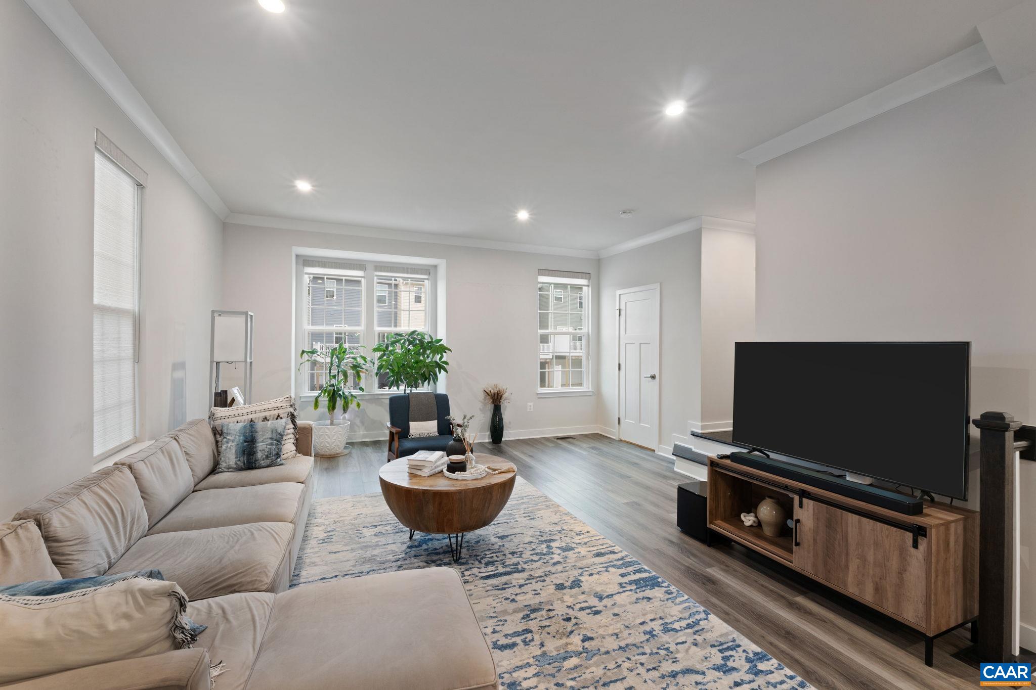 Alternate view of living area showcasing large windows, natural light, and comfortable layout. Alternate view of living area showcasing large windows, natural light, and comfortable layout.