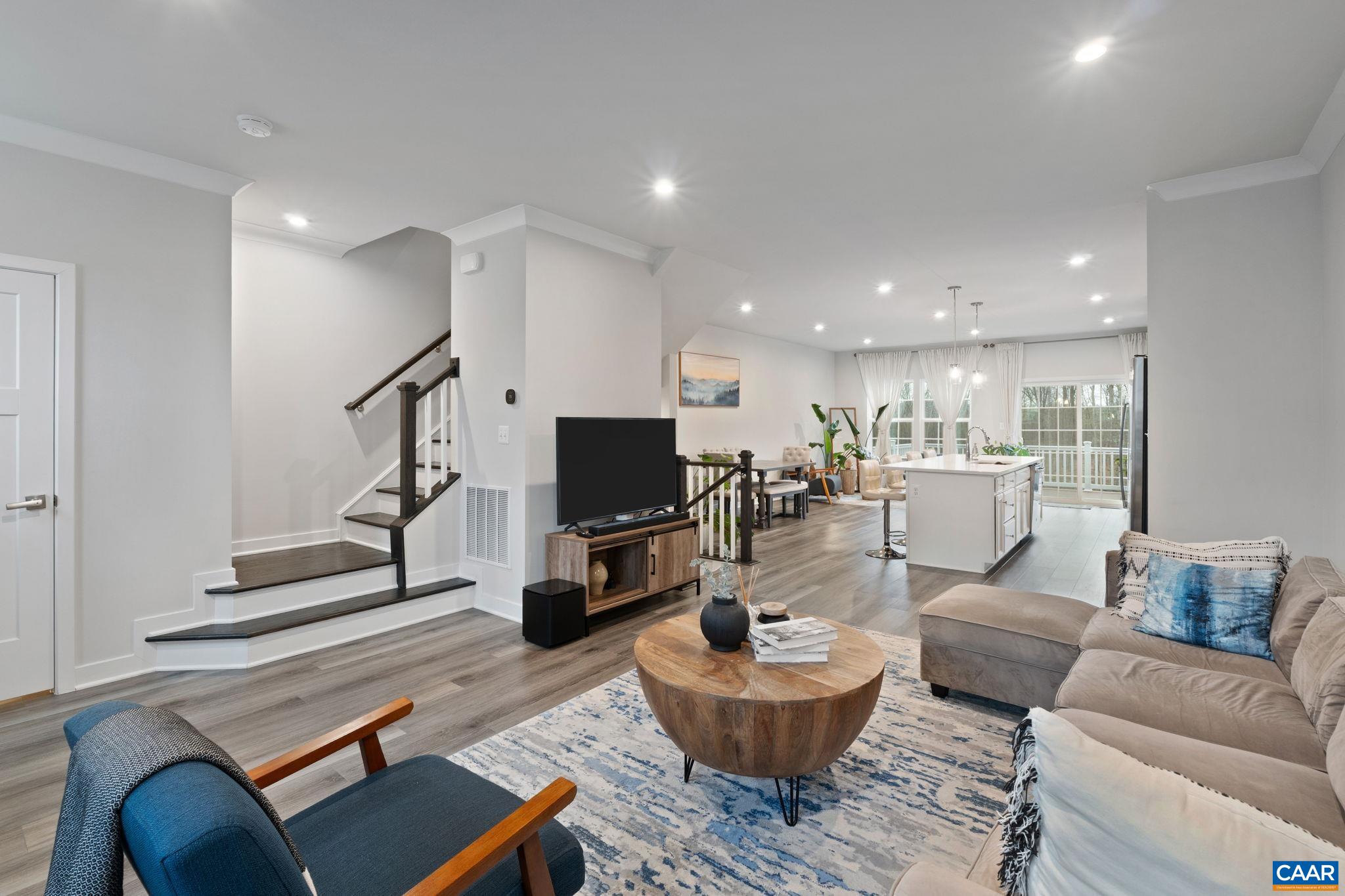 Bright open-concept main level featuring spacious living area flowing seamlessly into kitchen and dining, ideal for everyday living and entertaining. Bright open-concept main level featuring spacious living area flowing seamlessly into kitchen and dining, ideal for everyday living and entertaining.