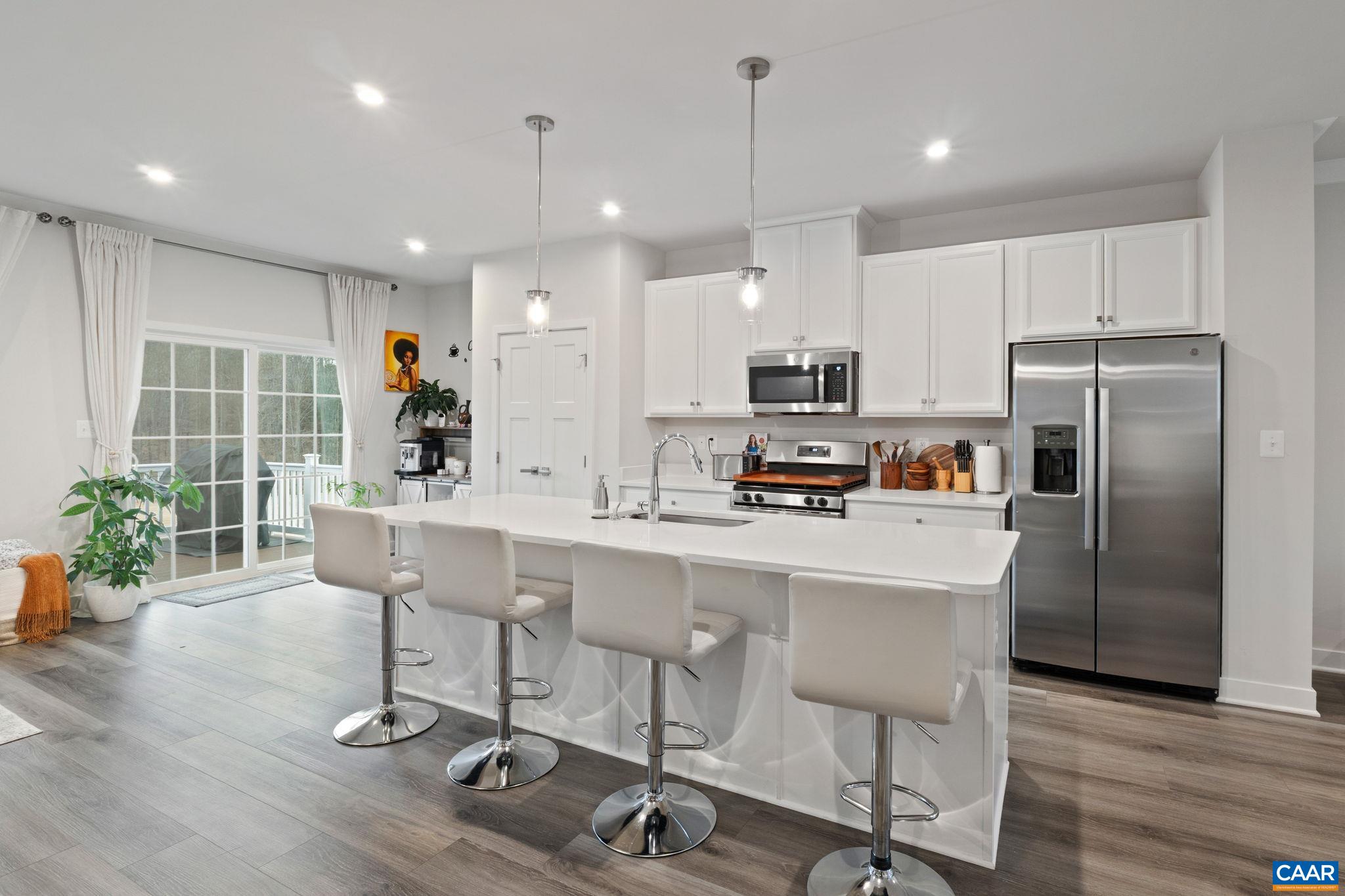 Modern kitchen featuring a large center island with seating, stainless steel appliances, and ample cabinetry—ideal for both cooking and entertaining. Modern kitchen featuring a large center island with seating, stainless steel appliances, and ample cabinetry—ideal for both cooking and entertaining.