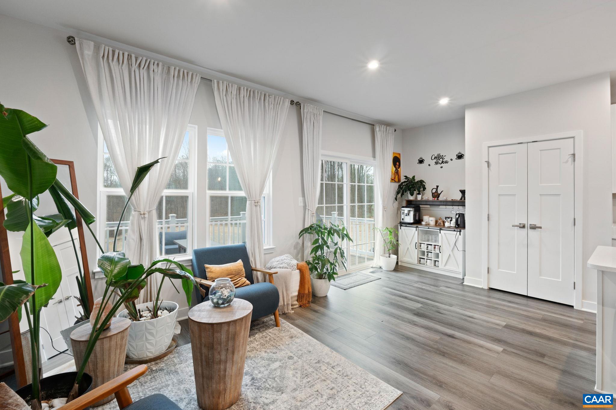 Bright dining area with large windows, abundant natural light, and direct access to the rear deck—creating an inviting space for everyday meals and indoor-outdoor living. Bright dining area with large windows, abundant natural light, and direct access to the rear deck—creating an inviting space for everyday meals and indoor-outdoor living.