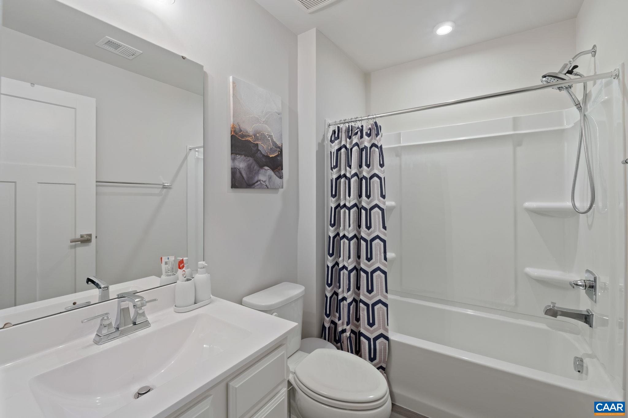 Clean and modern full bathroom featuring a tub/shower combo, single vanity, and bright neutral finishes—well-suited for guests or everyday use. Clean and modern full bathroom featuring a tub/shower combo, single vanity, and bright neutral finishes—well-suited for guests or everyday use.