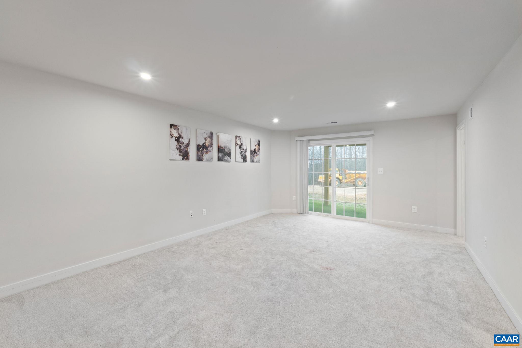 Spacious entry-level room with plush carpet, access to full bath, and walk-in closet—ideal for guest suite, office, or additional living space. Spacious entry-level room with plush carpet, access to full bath, and walk-in closet—ideal for guest suite, office, or additional living space.