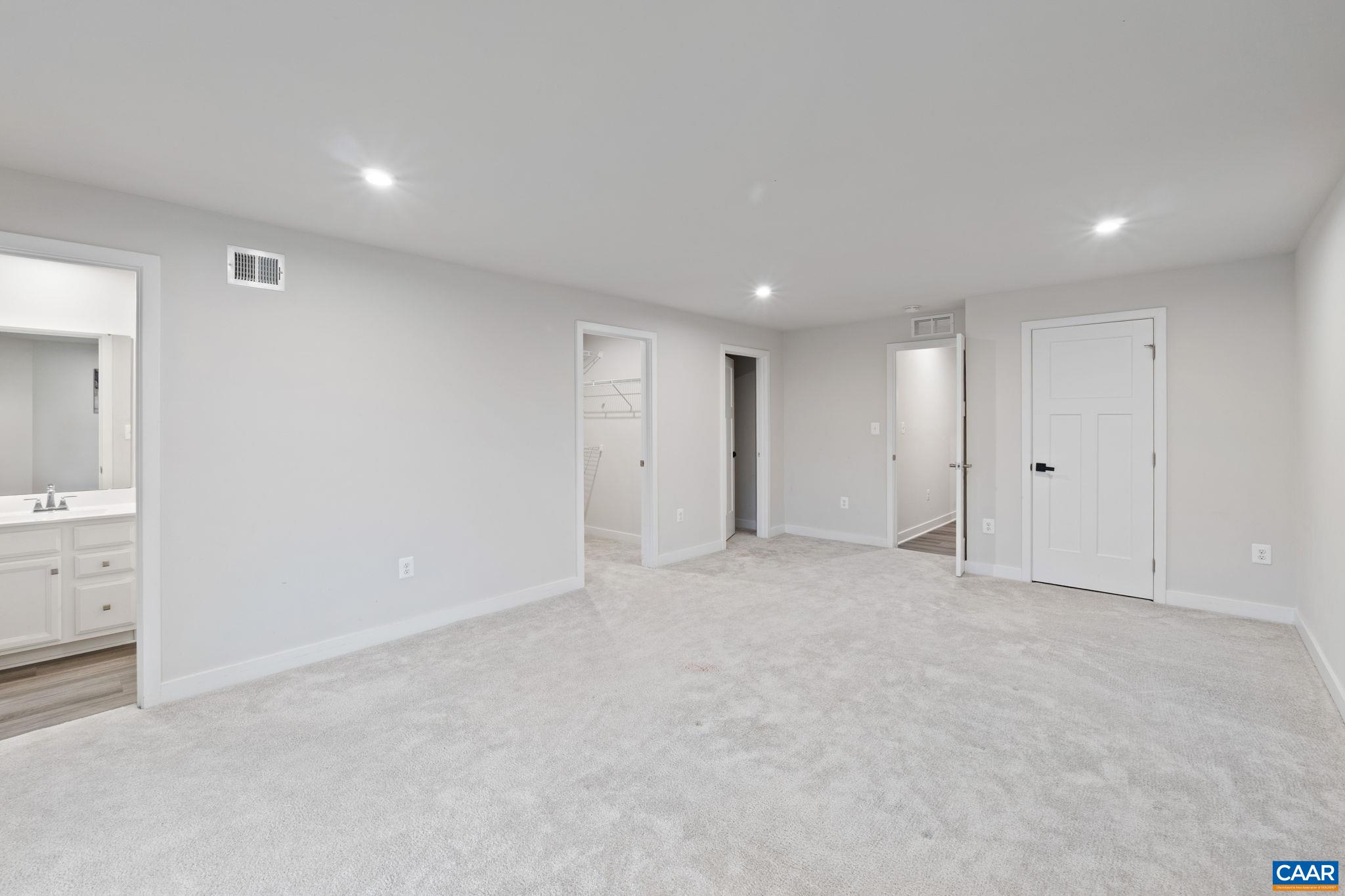 Alternate view of entry-level room showcasing open layout, natural light from sliding glass doors, and direct access to outdoor space. Alternate view of entry-level room showcasing open layout, natural light from sliding glass doors, and direct access to outdoor space.