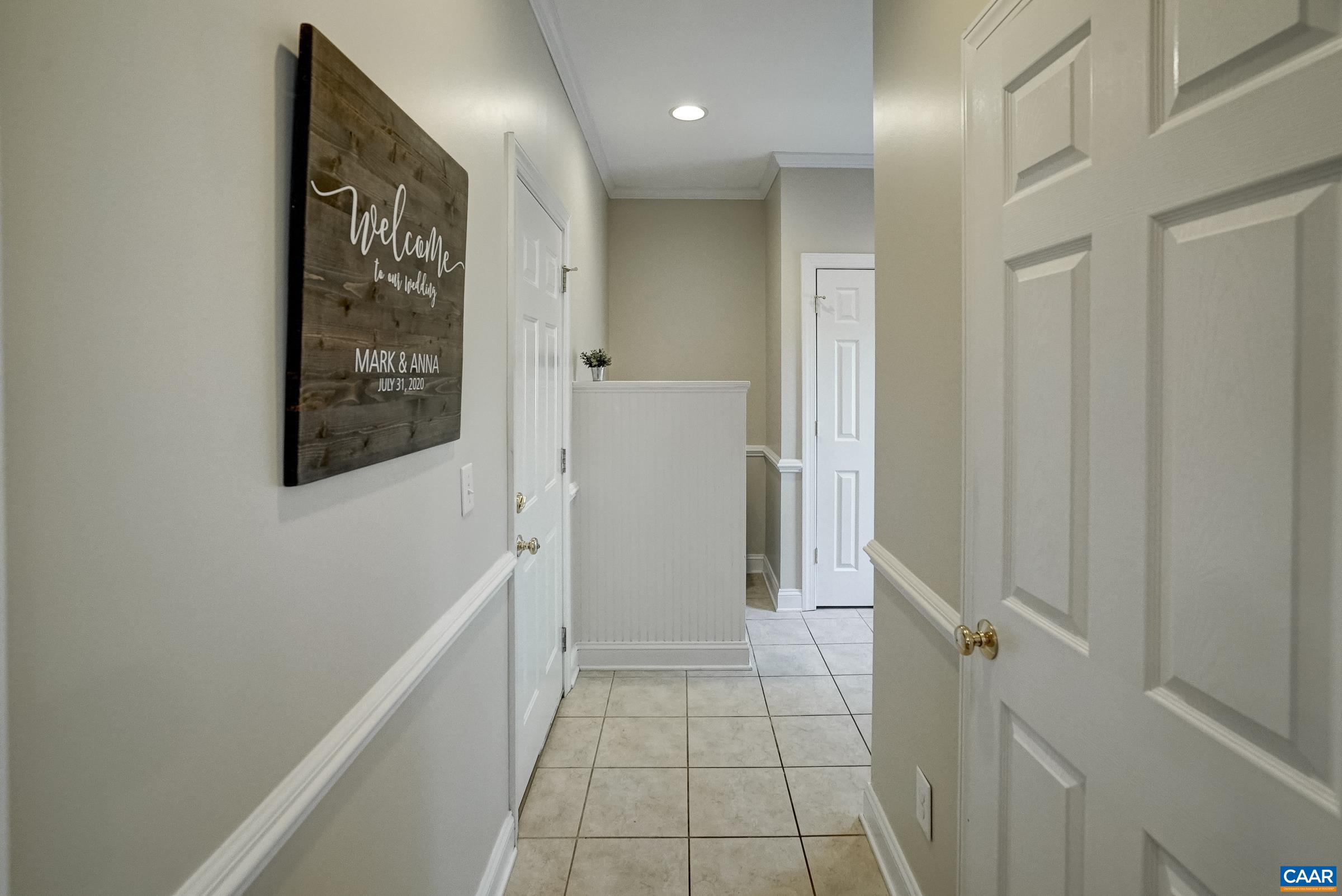 Large, tiled mudroom with utility sink for easy clean up.