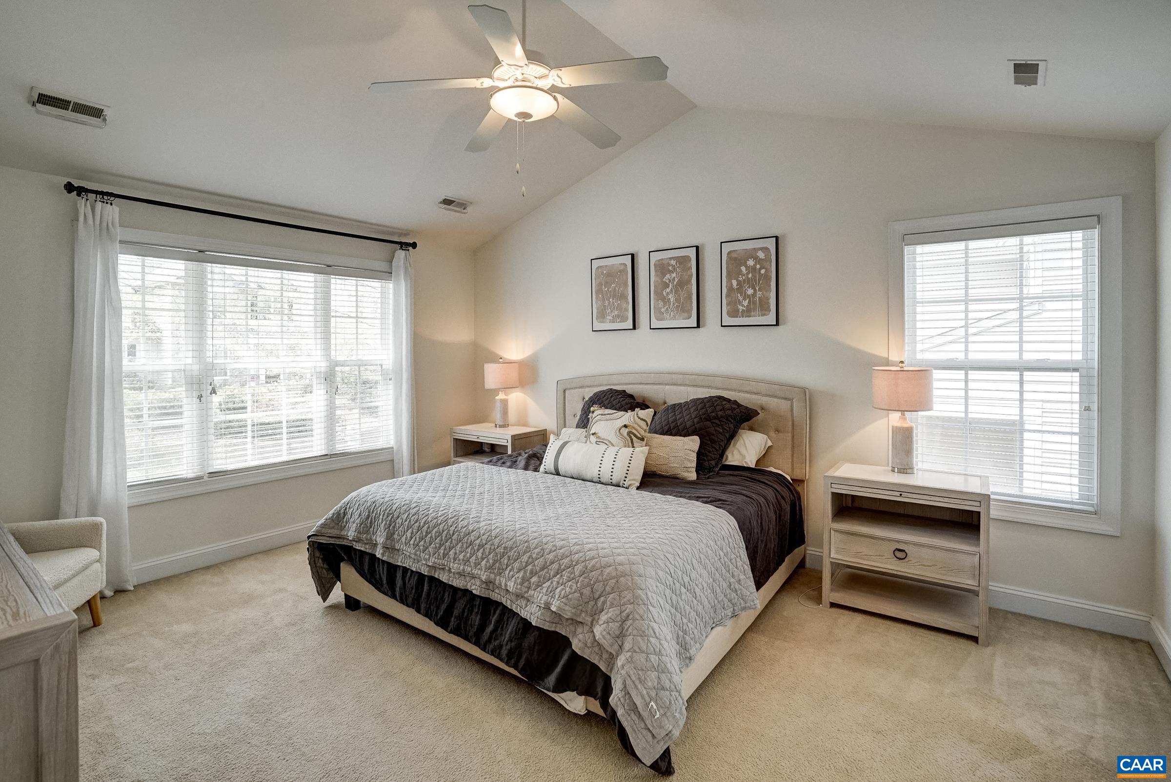 Second level primary suite with vaulted ceiling.