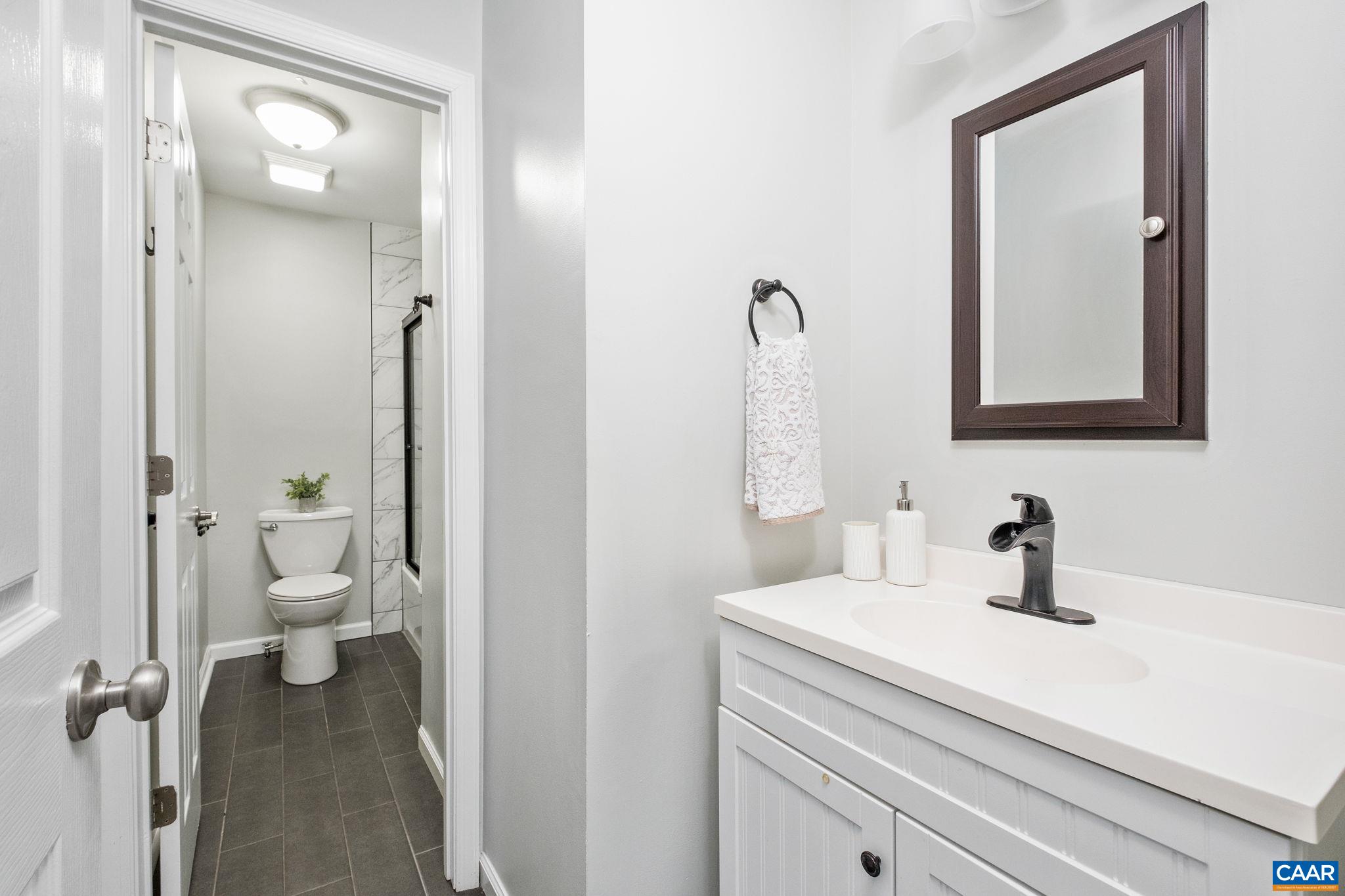 Full hall bathroom with new sliding shower doors, updated tile, new floors.