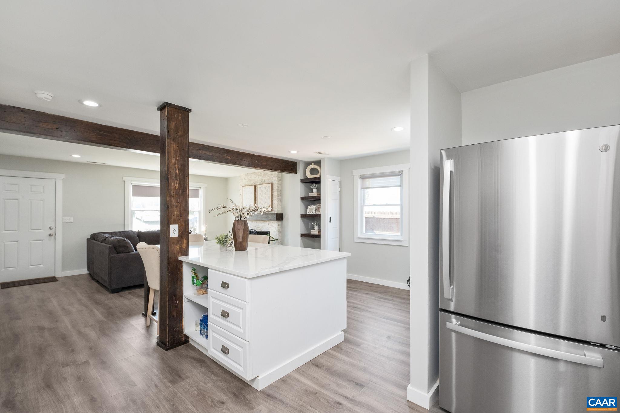 Spacious island with exposed beams is a focal point of the open floor plan.