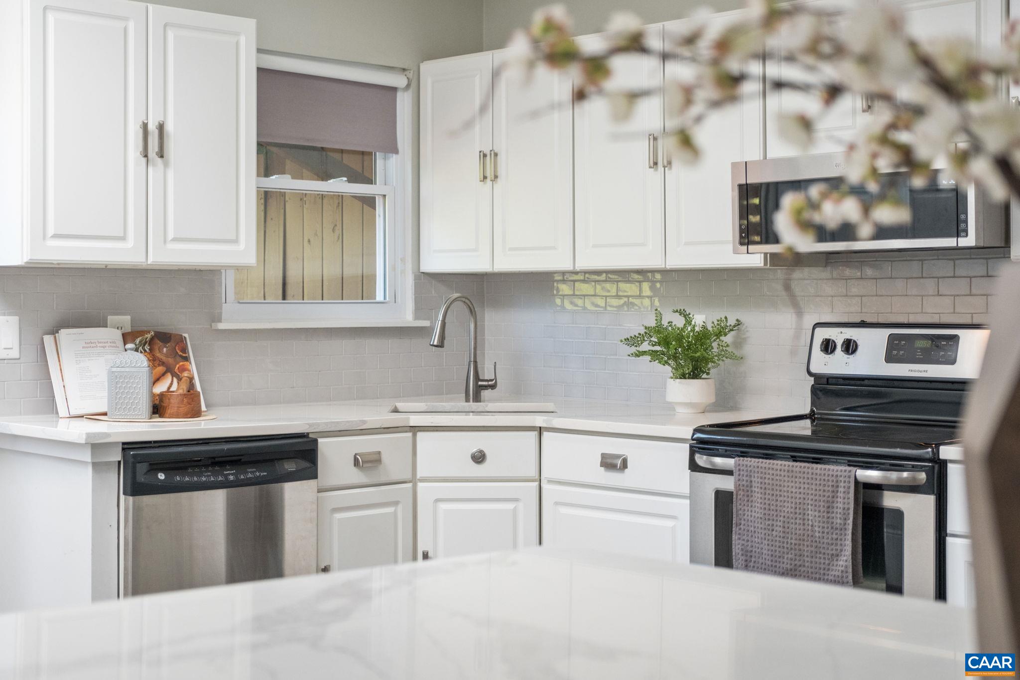White cabinets and stainless steel appliances.