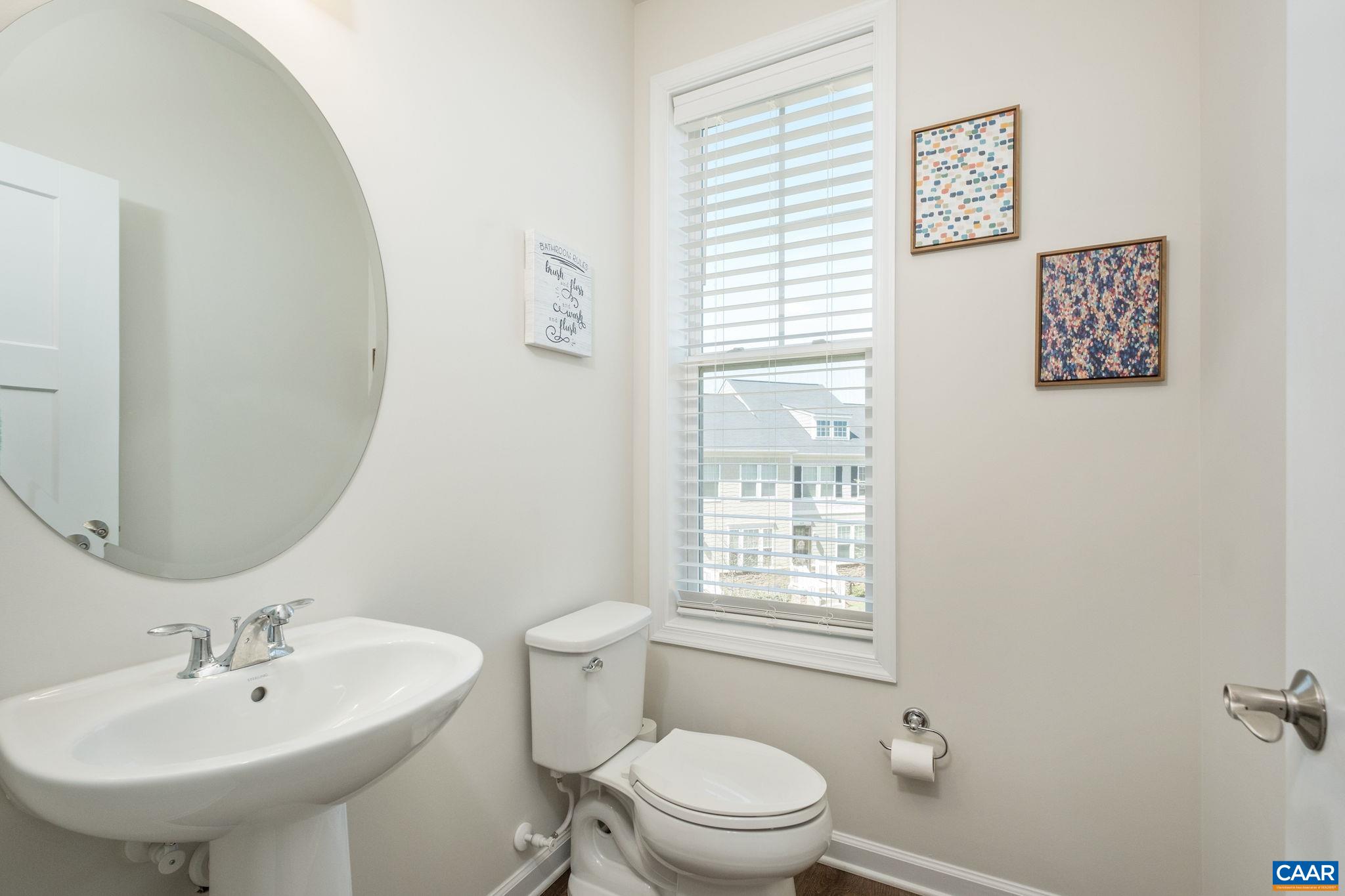 Large powder room with pedestal sink.