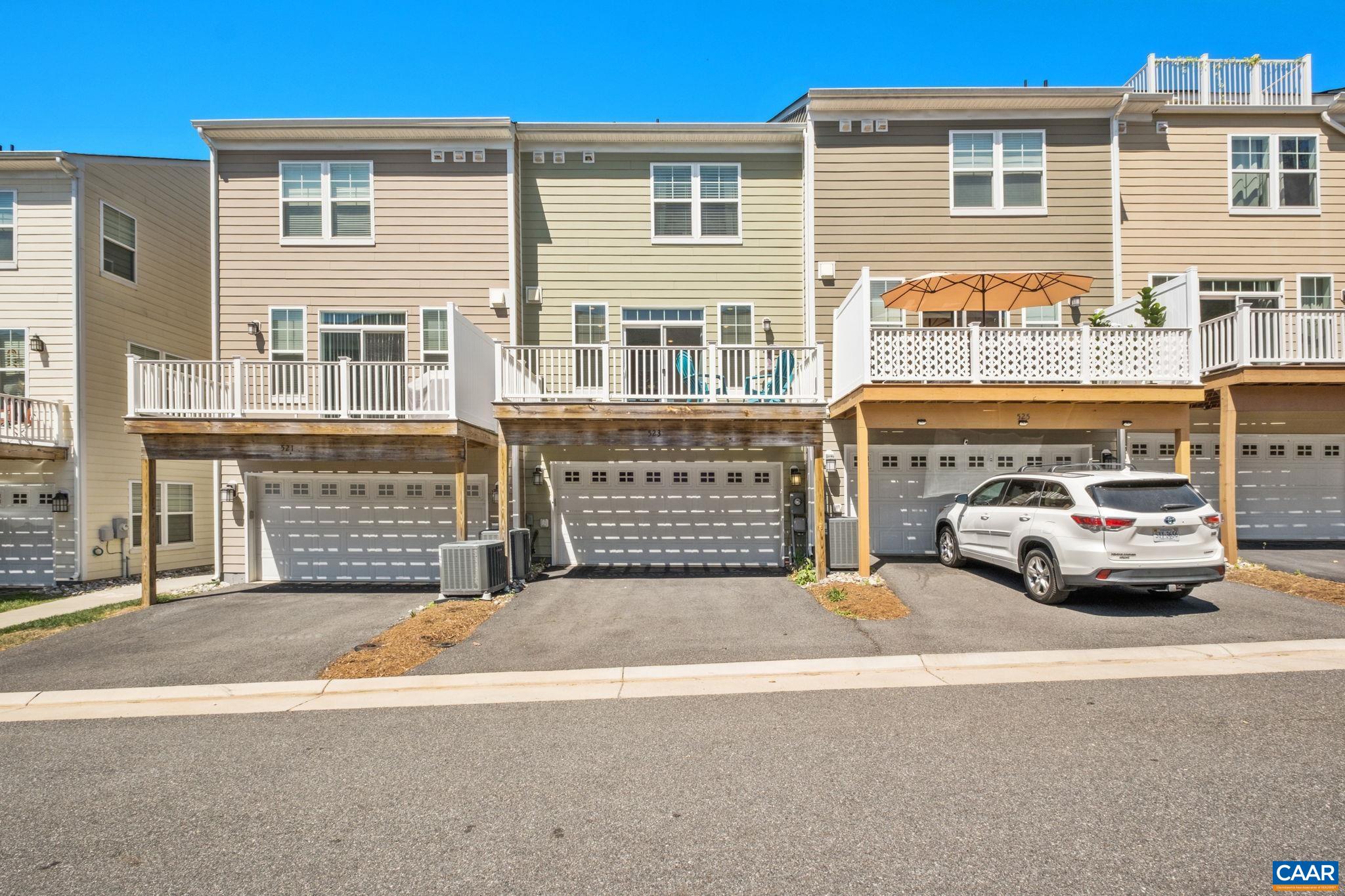 Two car garage with rear access, beautiful green space in front of home.
