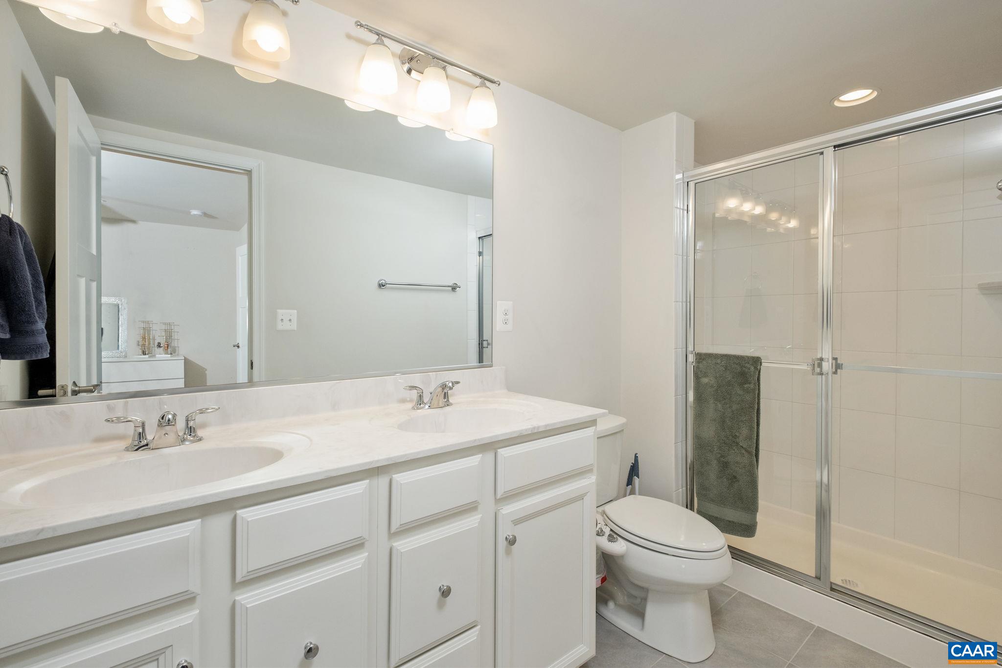 Double sink vanity and walk-in shower.