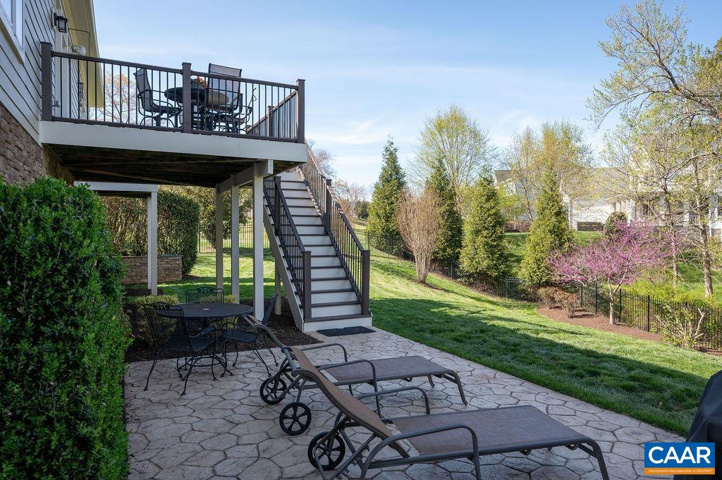 Back patio looks out over the beautifully landscaped yard and the common area.