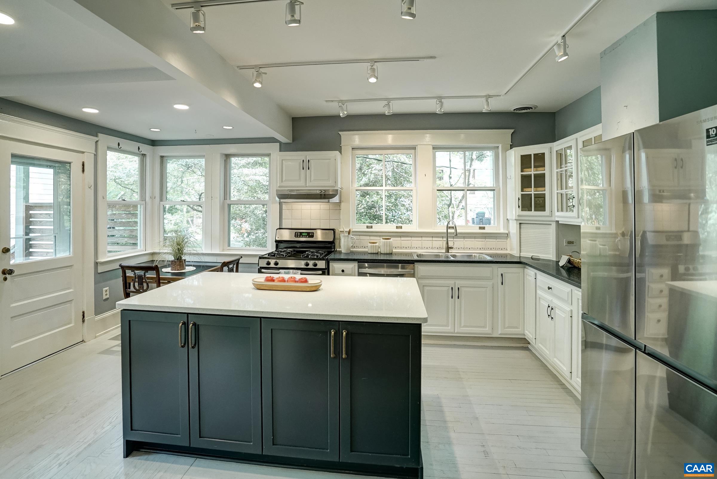 Updated kitchen with quartz countertops, and newly repainted cabinets, with stainless appliances.