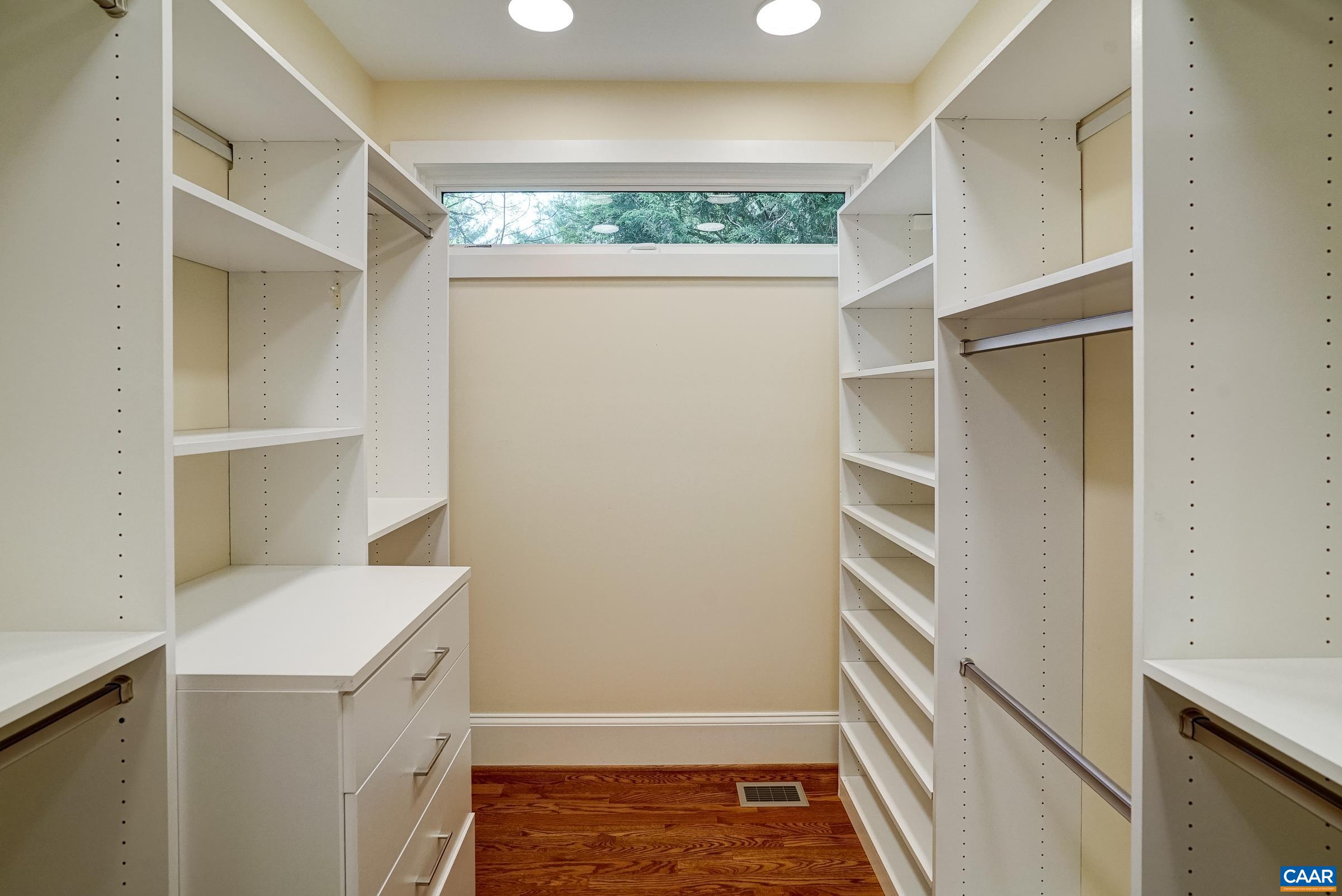 Large walk-in custom closet with sliding barn door.