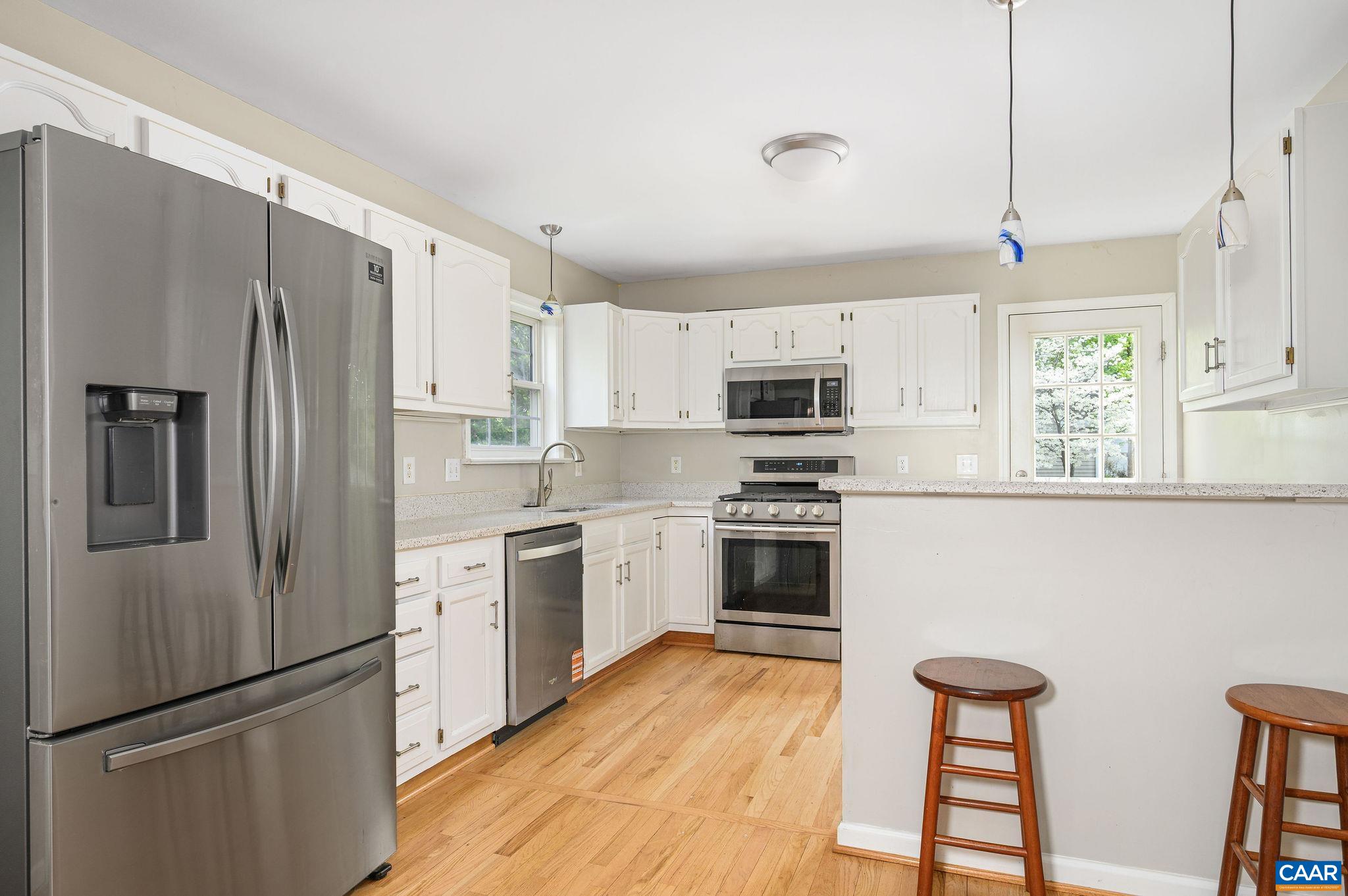 White cabinets, great pendant lighting, side door to driveway