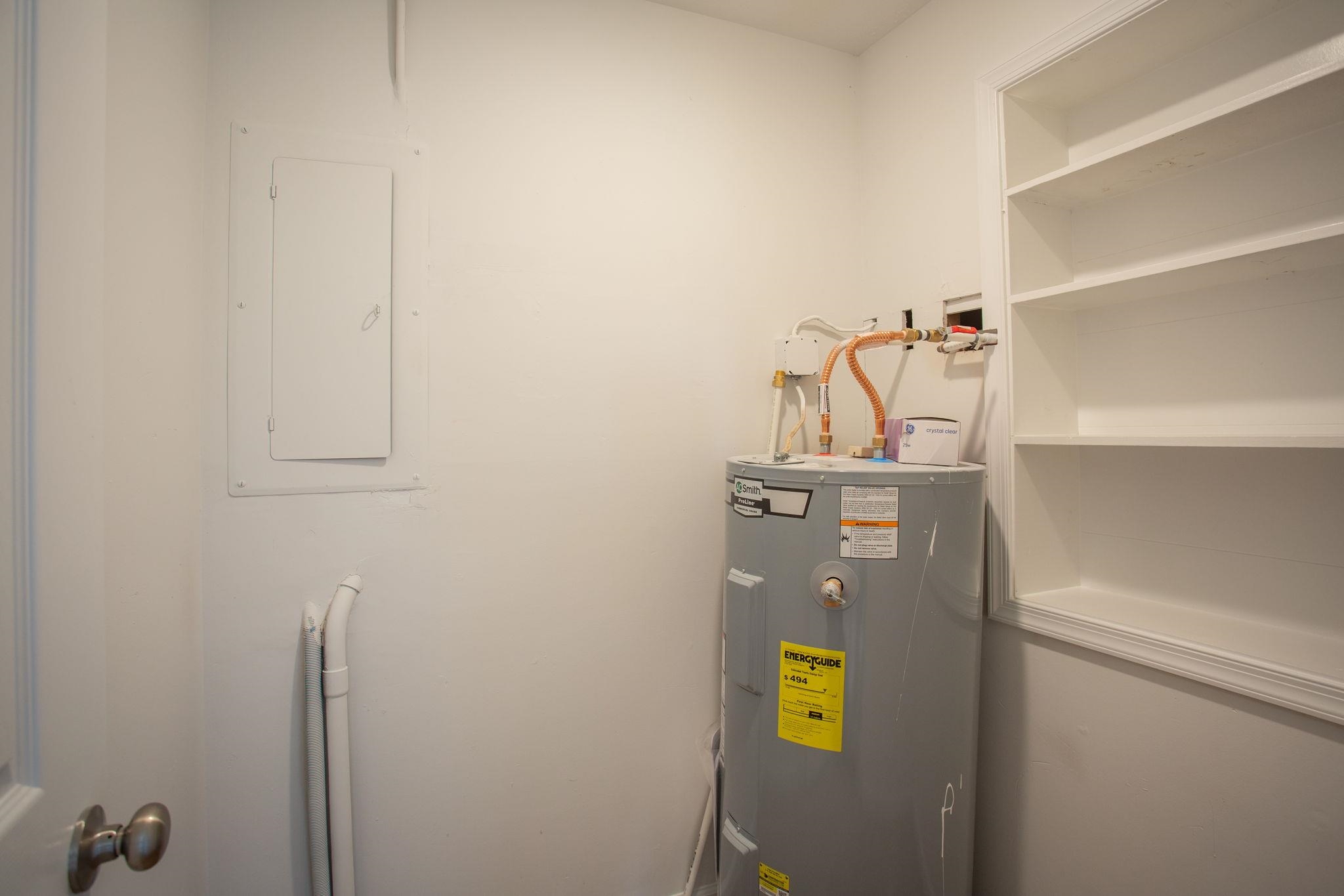 with hot water heater and space for storage.