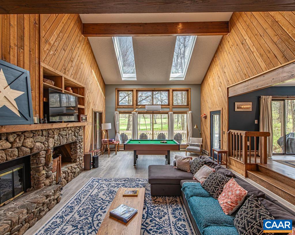 Great Room with Vaulted Ceiling, Wood Beams & Stone Fireplace