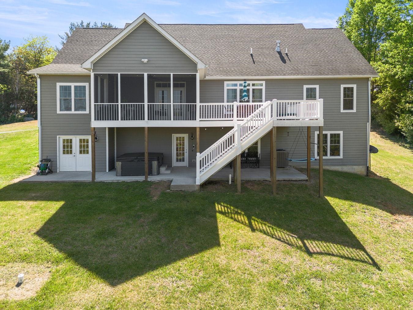 Rear Screened  Covered Deck and Uncovered Deck Area with Concrete Patio Underneath